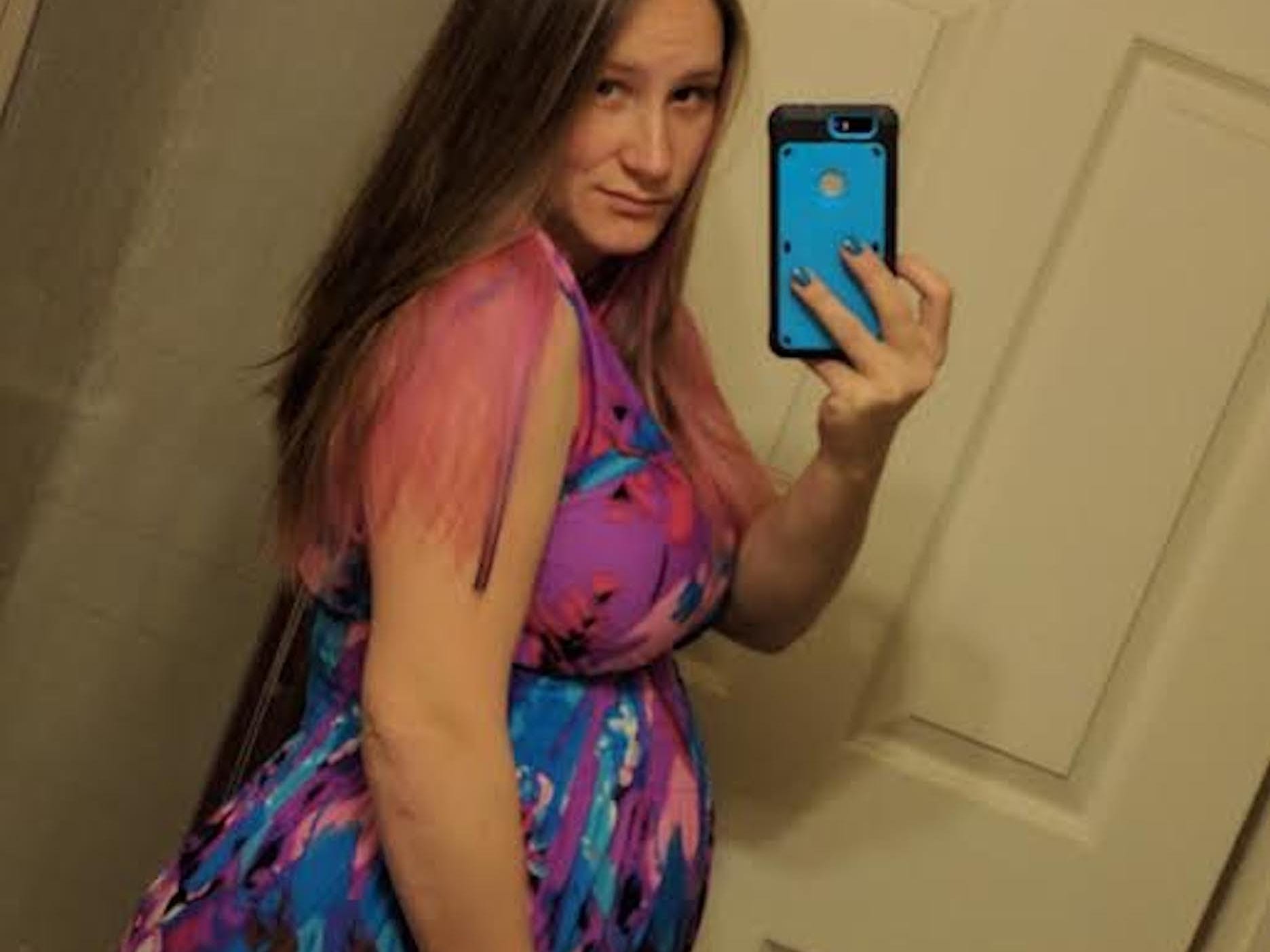 Cynthia Ortiz holding her pregnant belly.