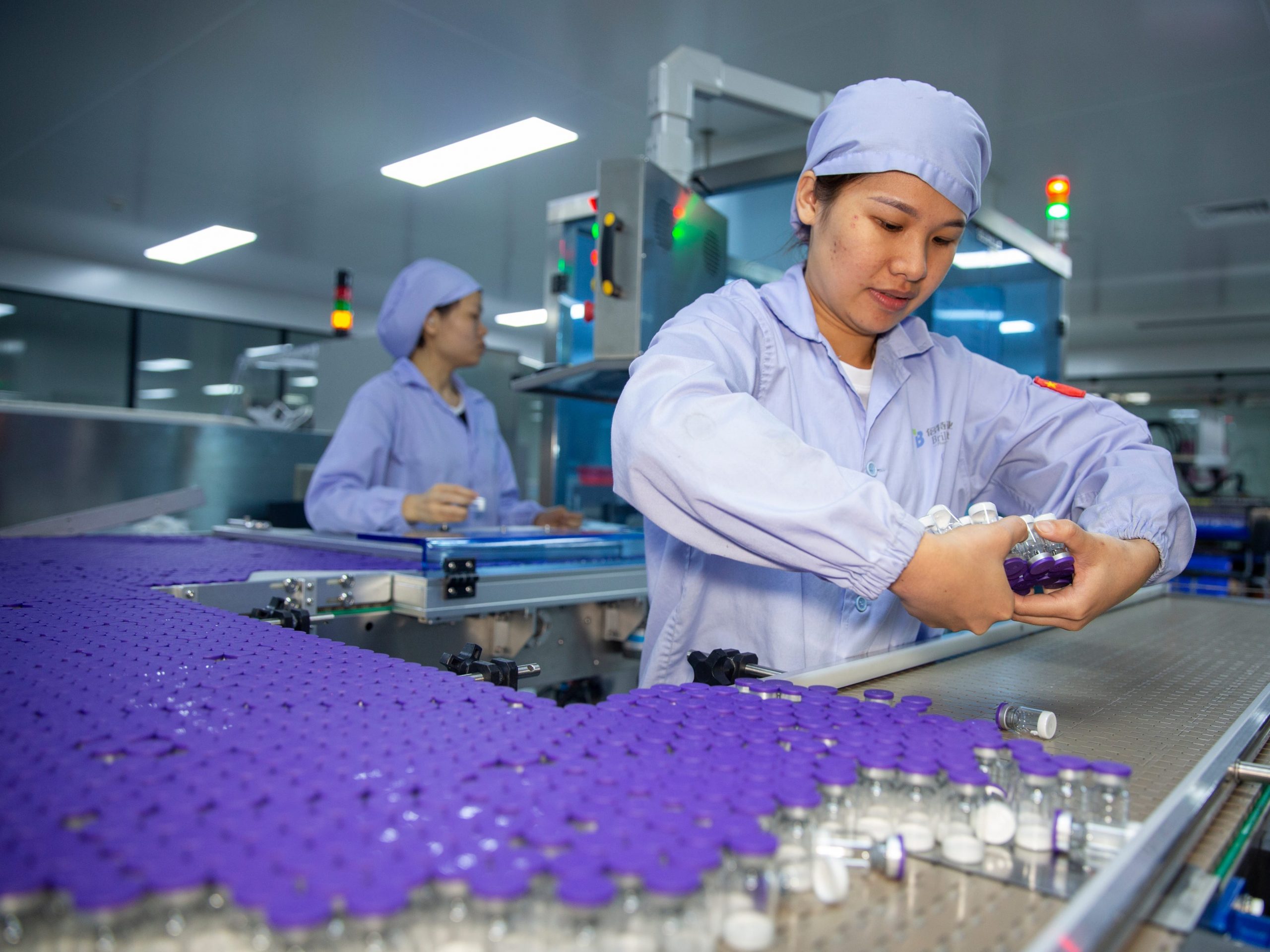 Employees work at a workshop in Haikou Brilliant Pharmaceutical Co., Ltd.