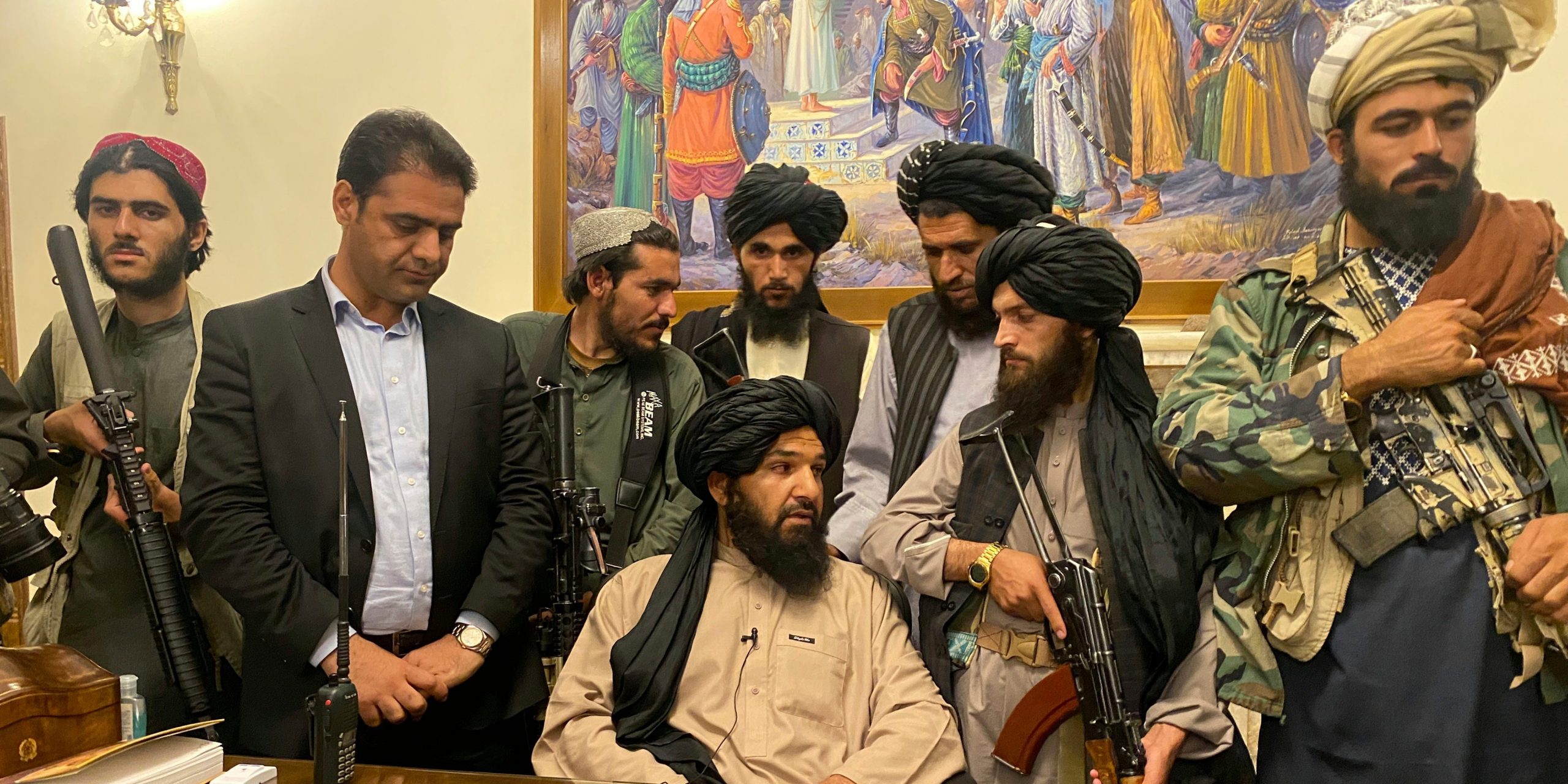 Taliban fighters sit in the Afghan presidential palace.