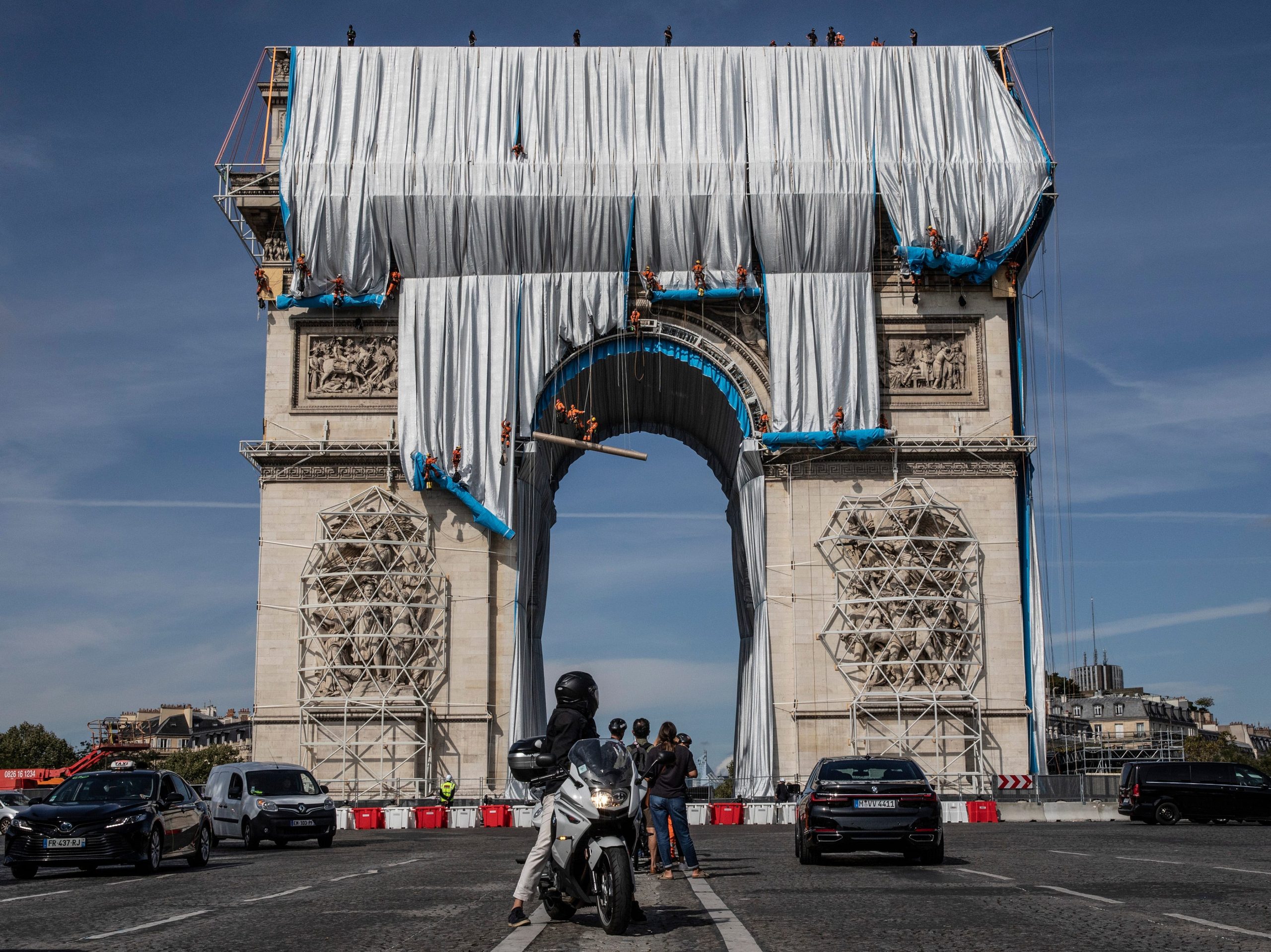 Workers begin the process of wrapping up the Arc De Triomphe monument in silver-blue fabric on September 12, 2021, in Paris, France.