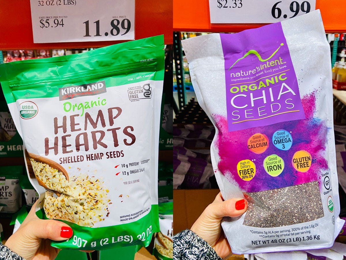 On the left, a hand holding a green and white pack of hemp hearts. On the right, a hand holding a purple and white bag of chia seeds