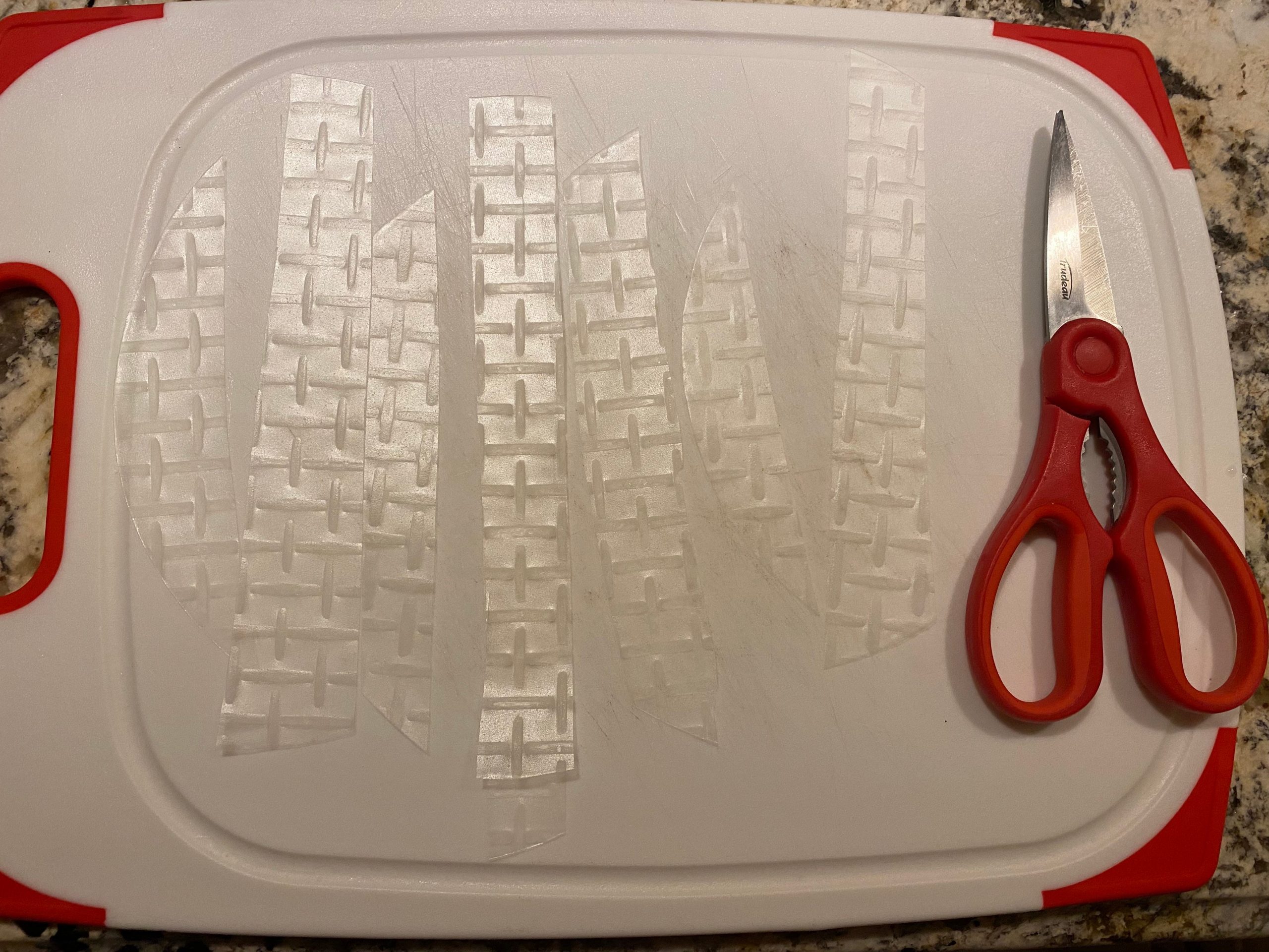 strips of rice paper and scissors on a cutting board