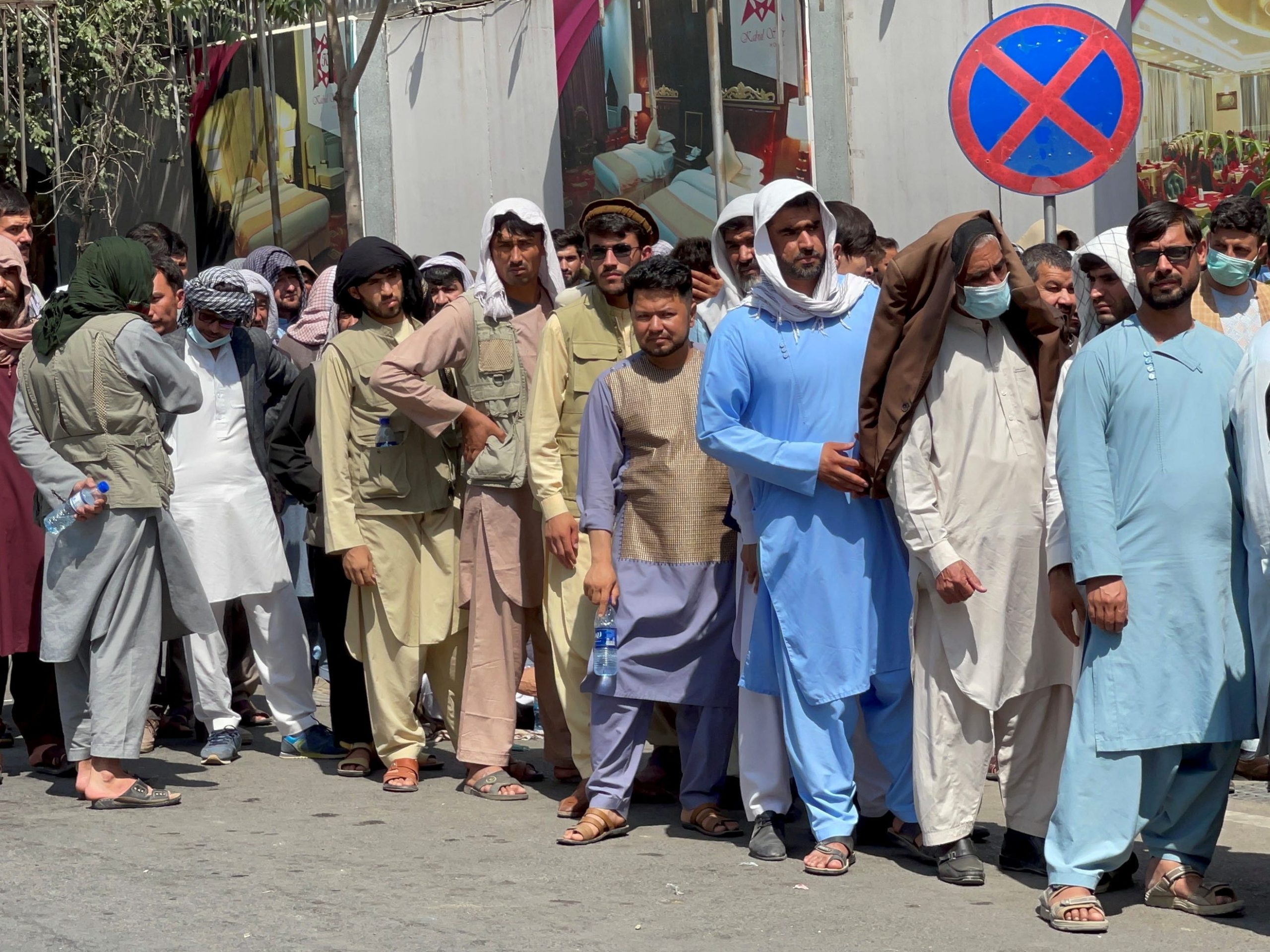 Afghans line up outside a bank to take out their money after Taliban takeover in Kabul, Afghanistan September 1, 2021.