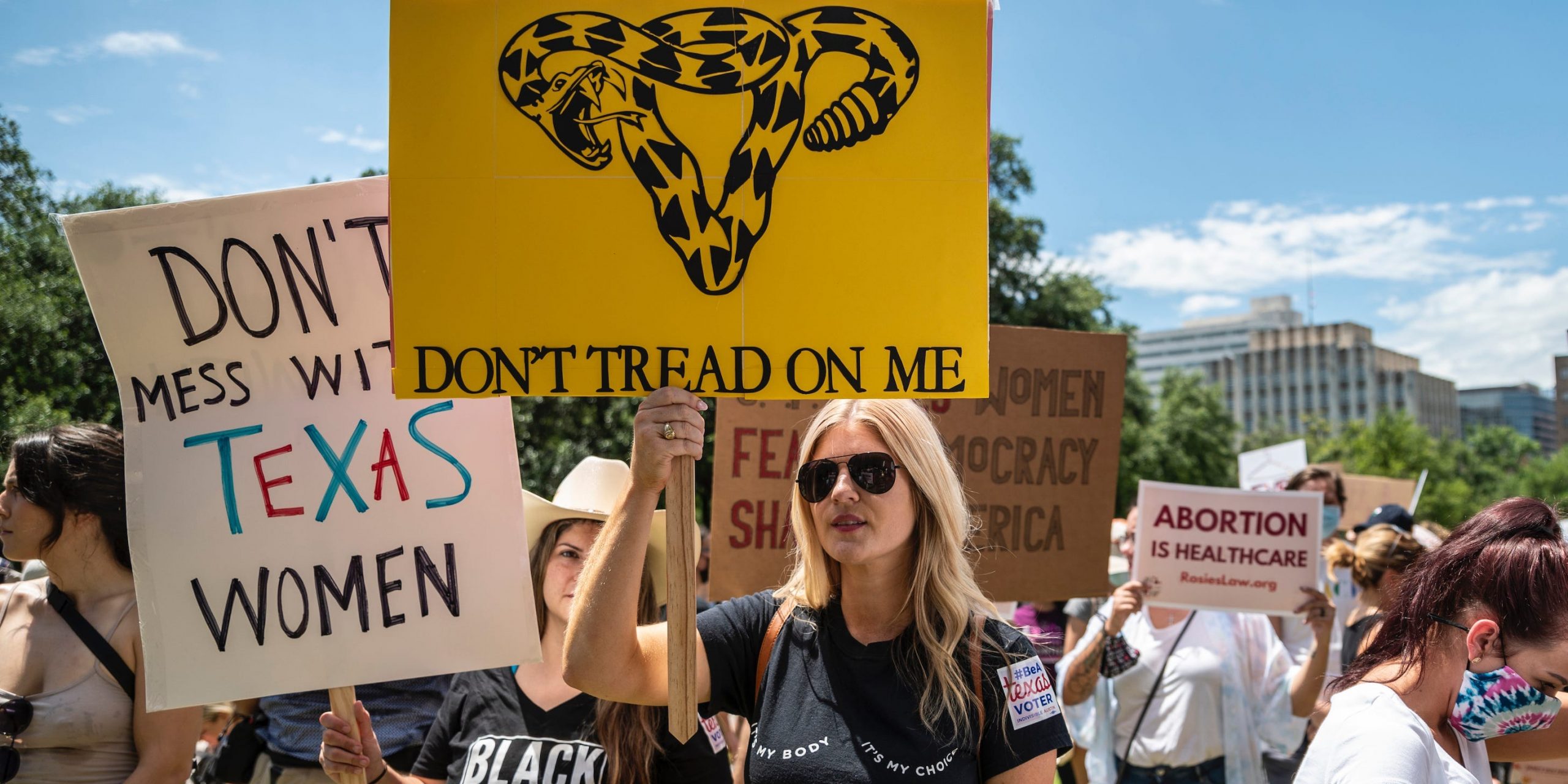 Protesters hold up signs at a protest against Texas' new abortion law outside the state capitol on May 29, 2021 in Austin, Texas.