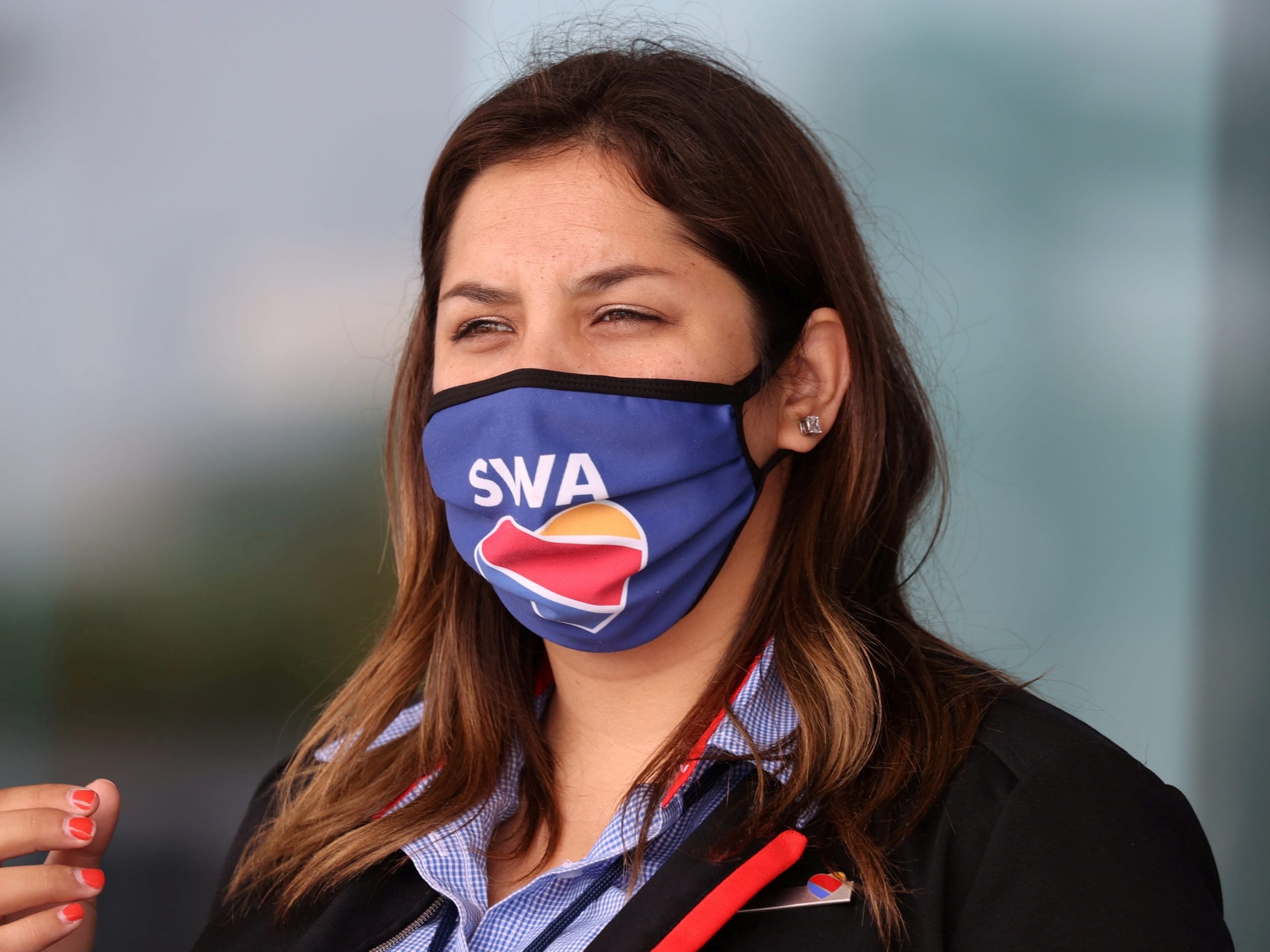 A gate agent wears a Southwest Airlines mask