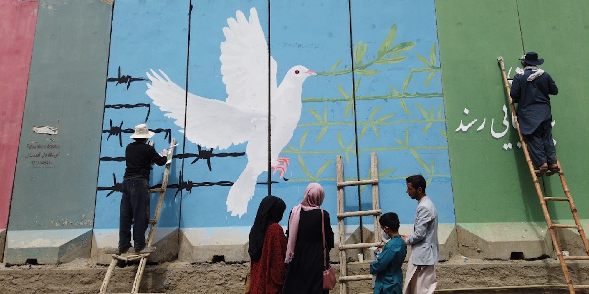 people painting mural