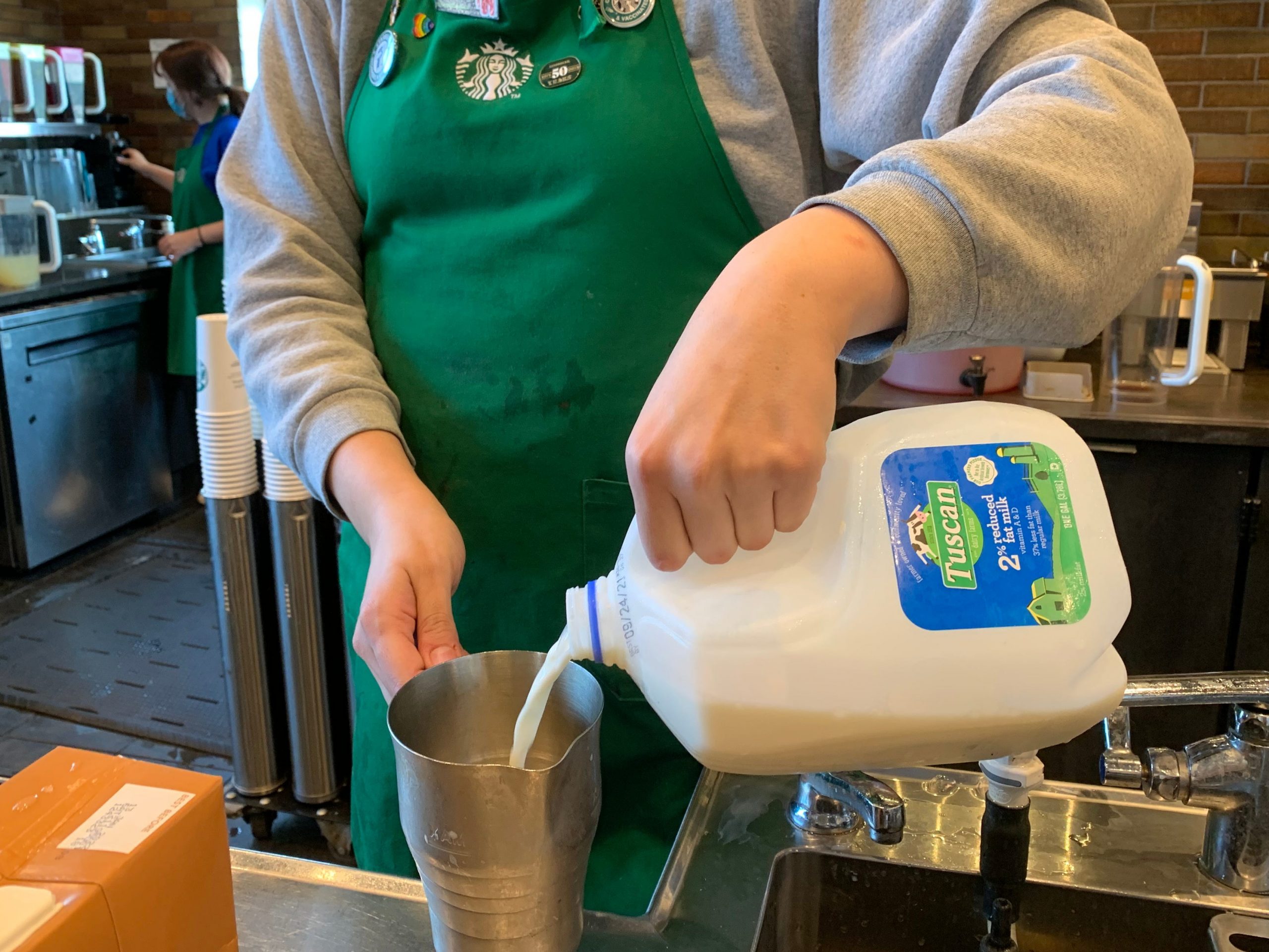Starbucks worker making a drink