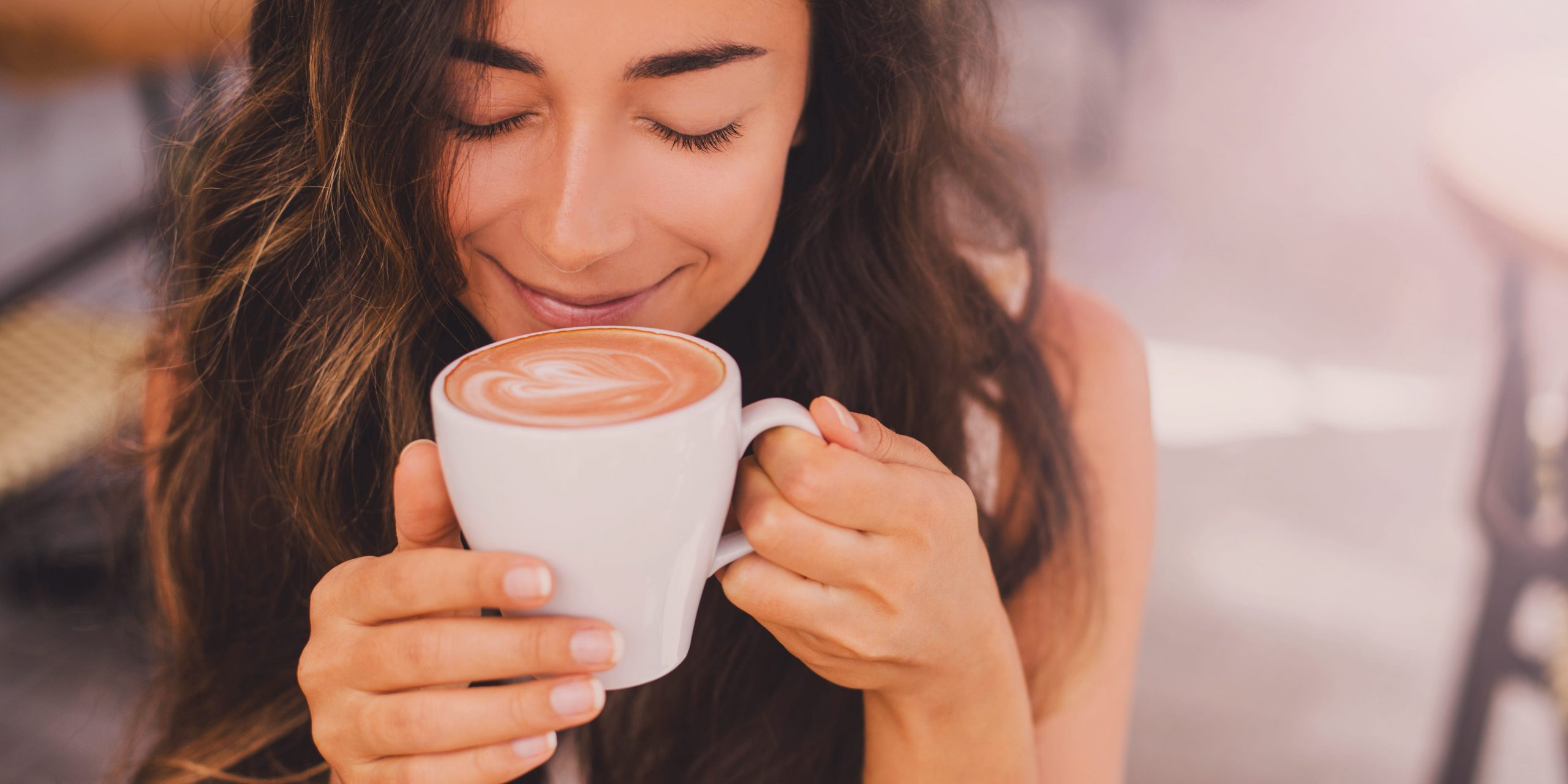 Brown haired woman drinking coffee