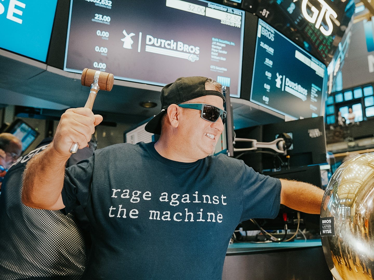 Travis Boersma imitates hitting the ceremonial bell at the New York Stock Exchange.