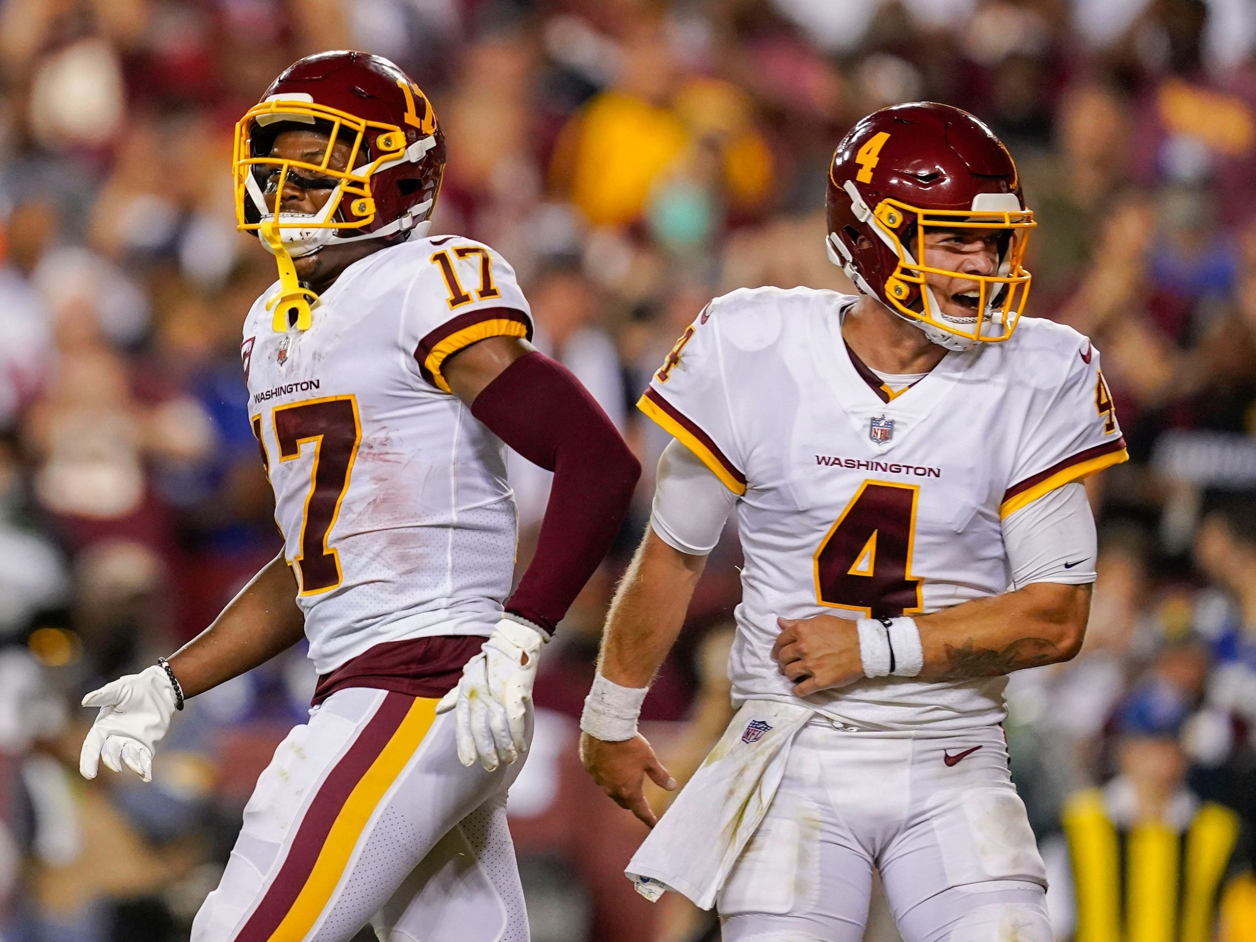 Taylor Heinicke celebrates with Terry McLaurin after a touchdown.