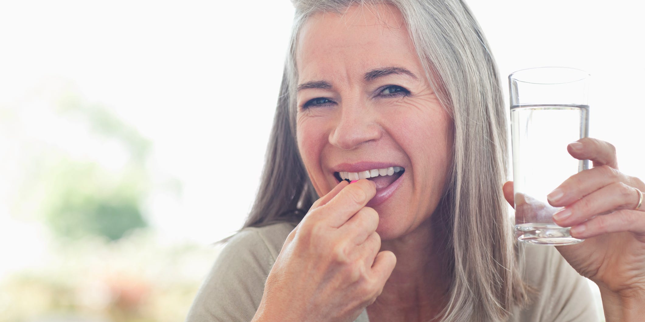 older woman taking her medication