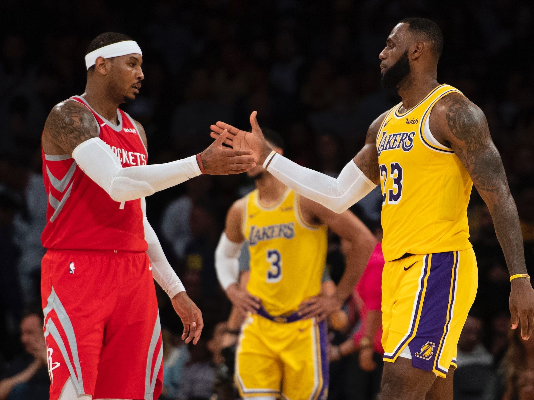 Carmelo Anthony and LeBron James shake hands during a game in 2018.