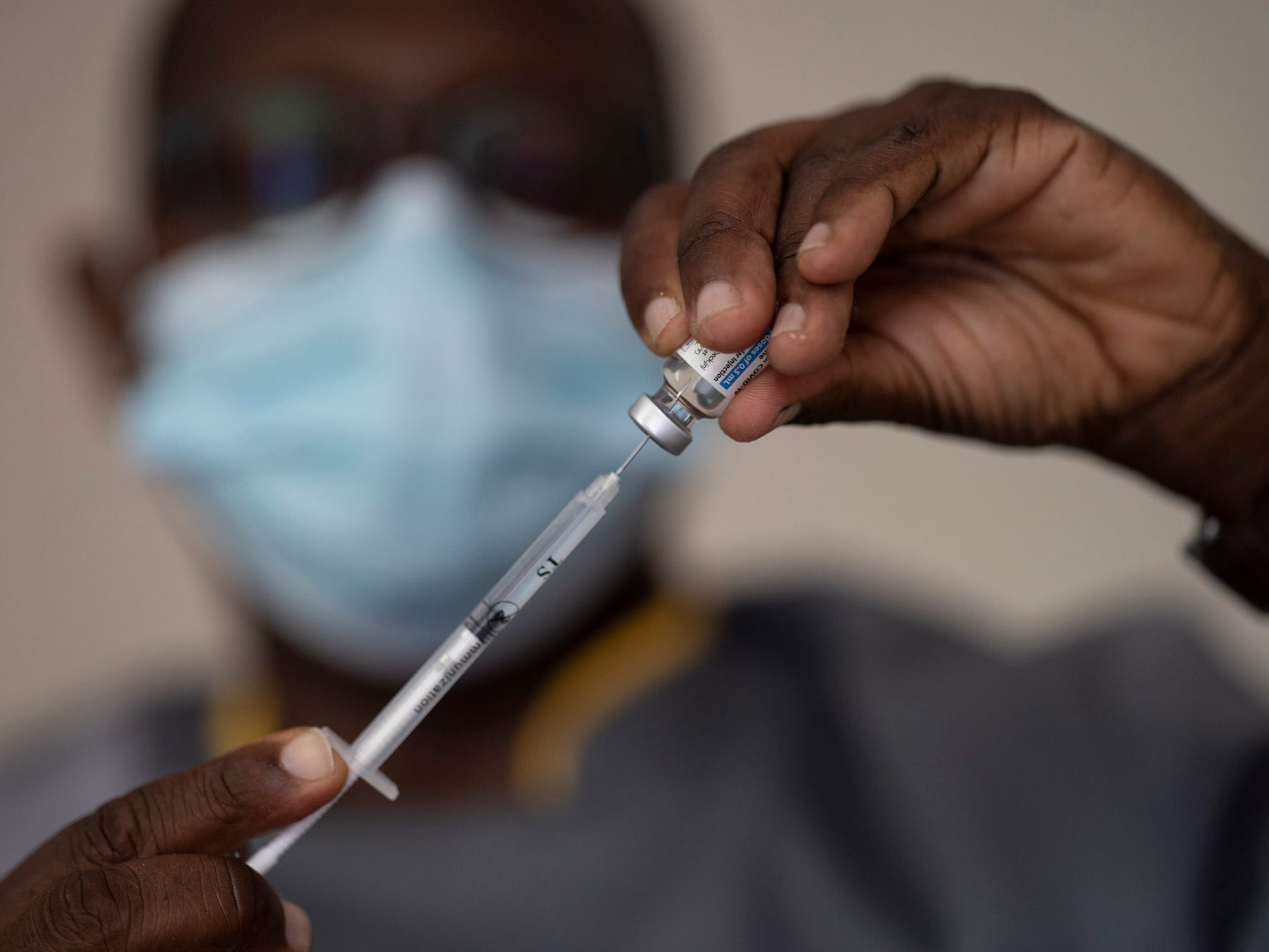 In this Wednesday, July 28, 2021 file photo, a health worker administers a dose of Janssen COVID-19 vaccine by Johnson & Johnson in the Medina neighborhood in Dakar, Senegal.