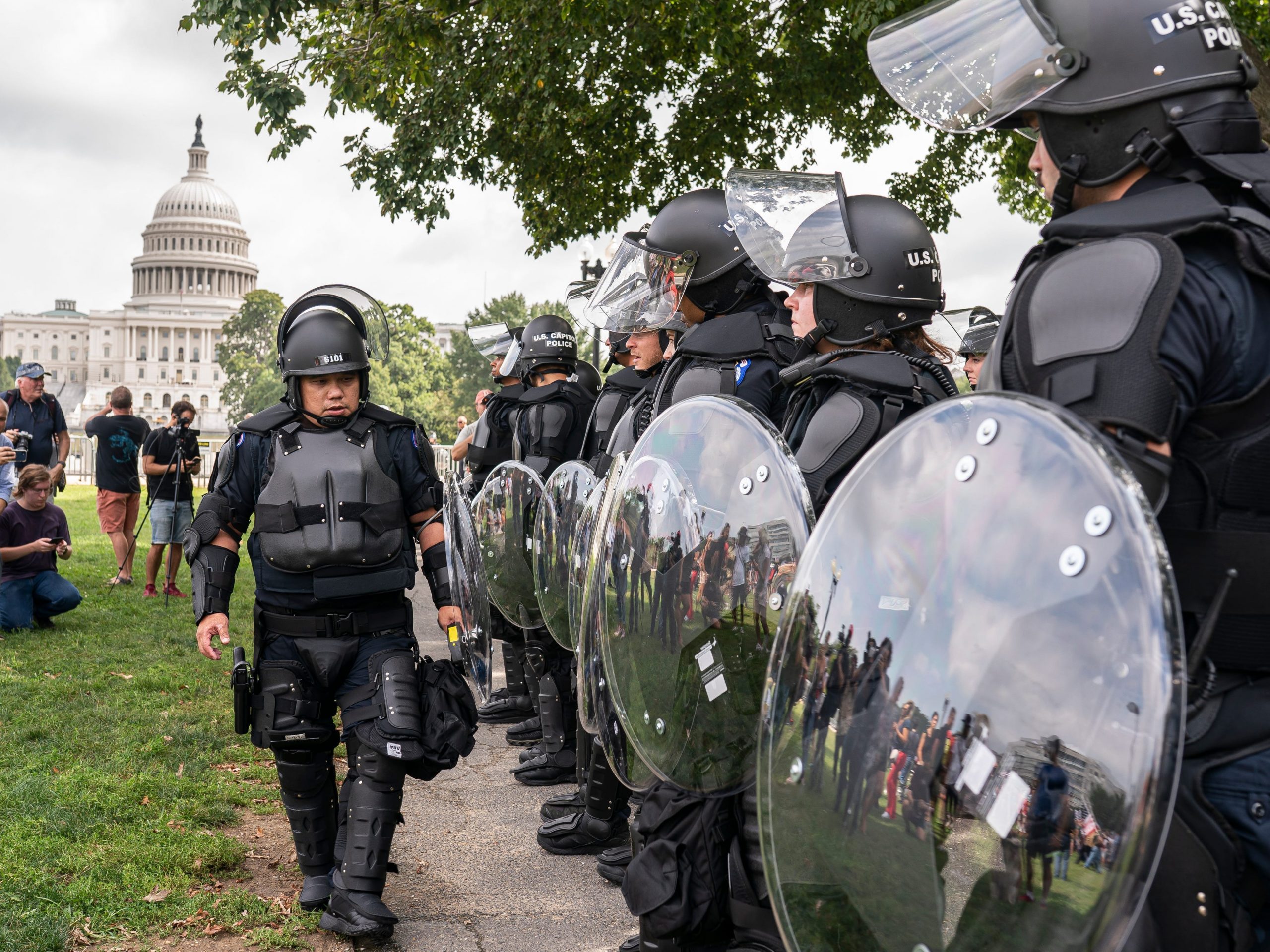 Police in riot gear observe the Justice for J6 rally near the U.S. Capitol in Washington, Saturday, Sept. 18, 2021.
