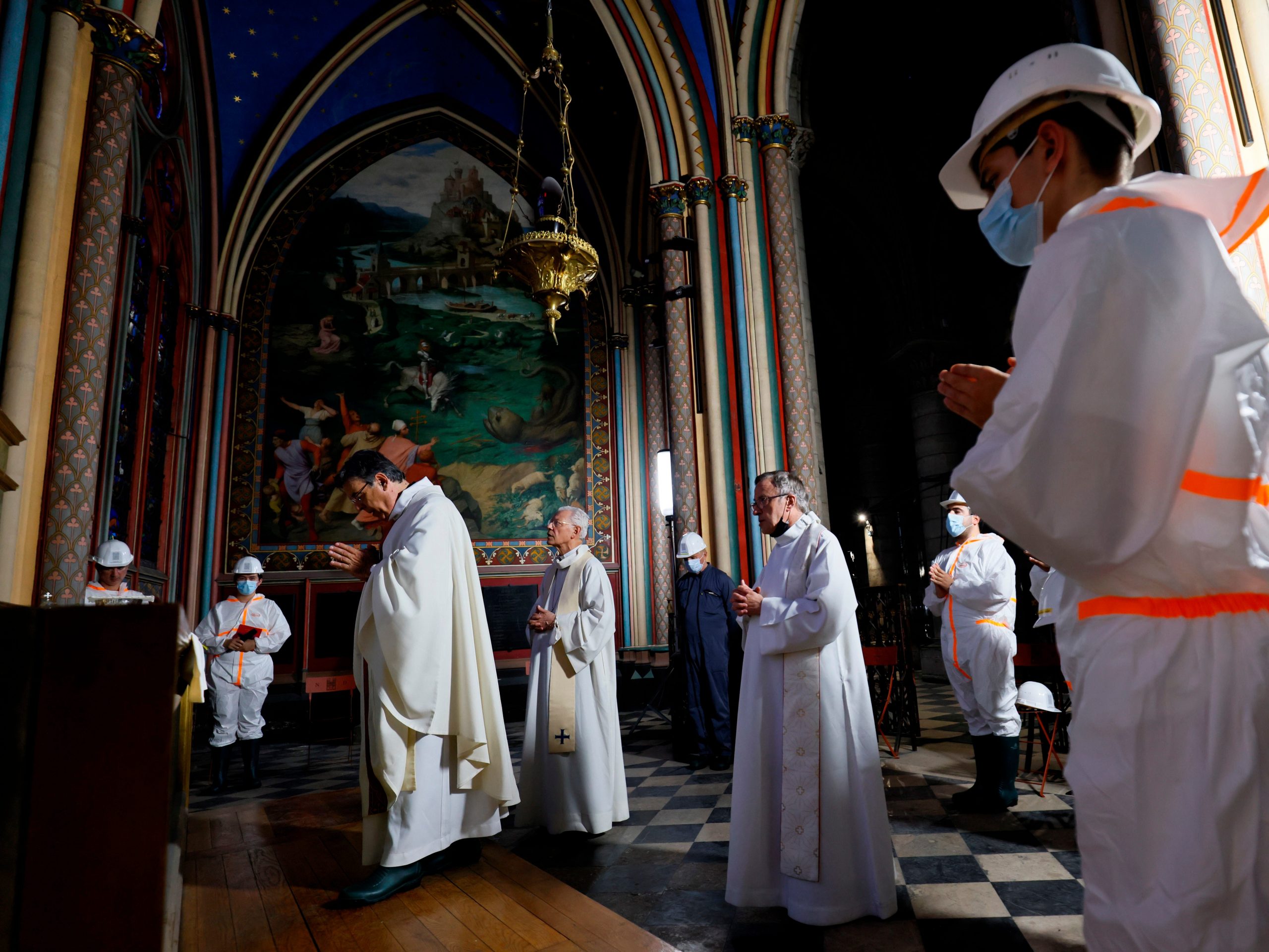 Paris archbishop Michel Aupetit, third left, celebrates a mass next to Patrick Chauvet, center, during a mass to call for more donations by faithfuls for the renovation of the monument ravaged two years ago by a fire at Notre Dame Cathedral Wednesday June 16 2021 in Paris.