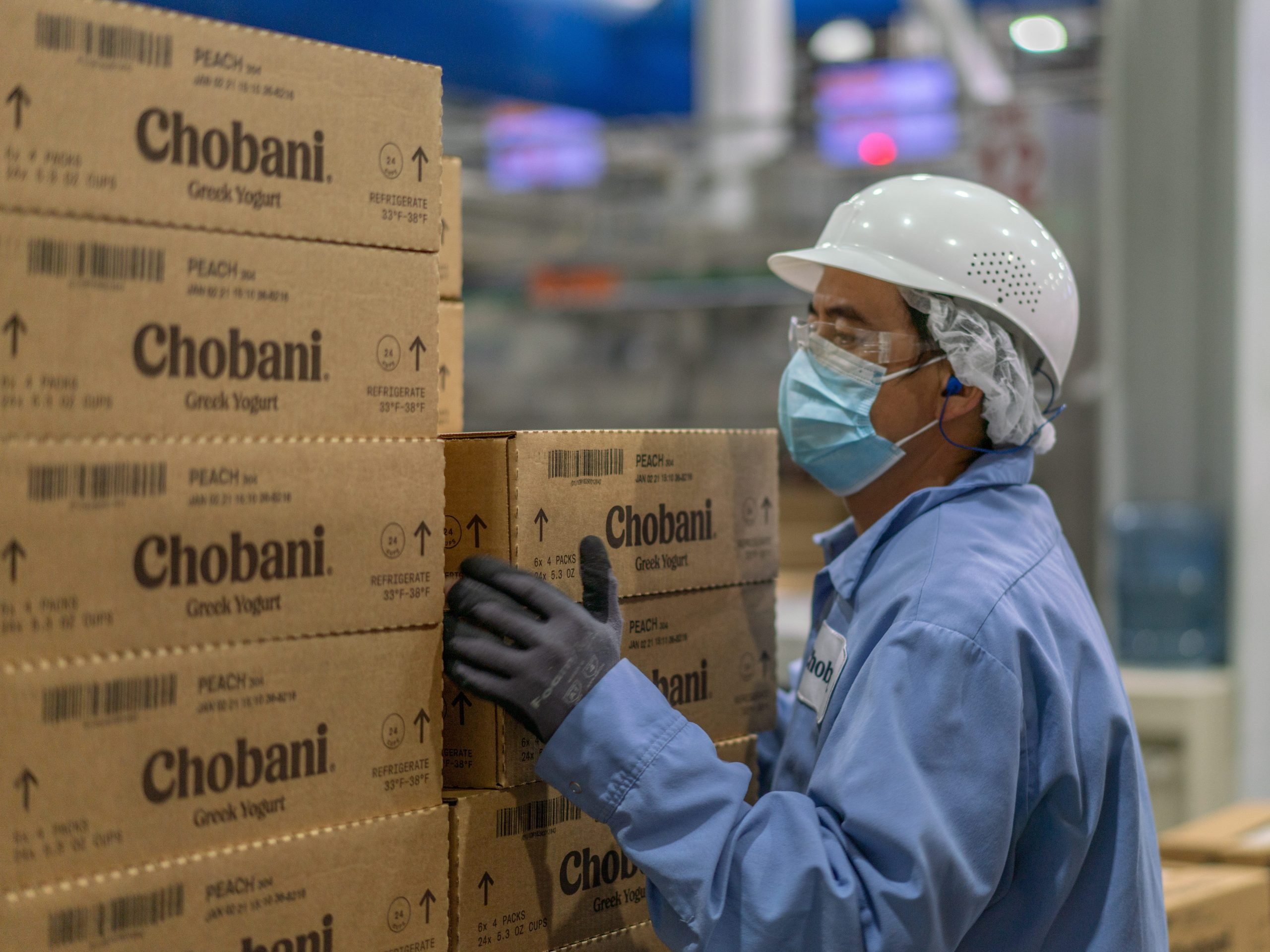 Chobani employee stacking boxes