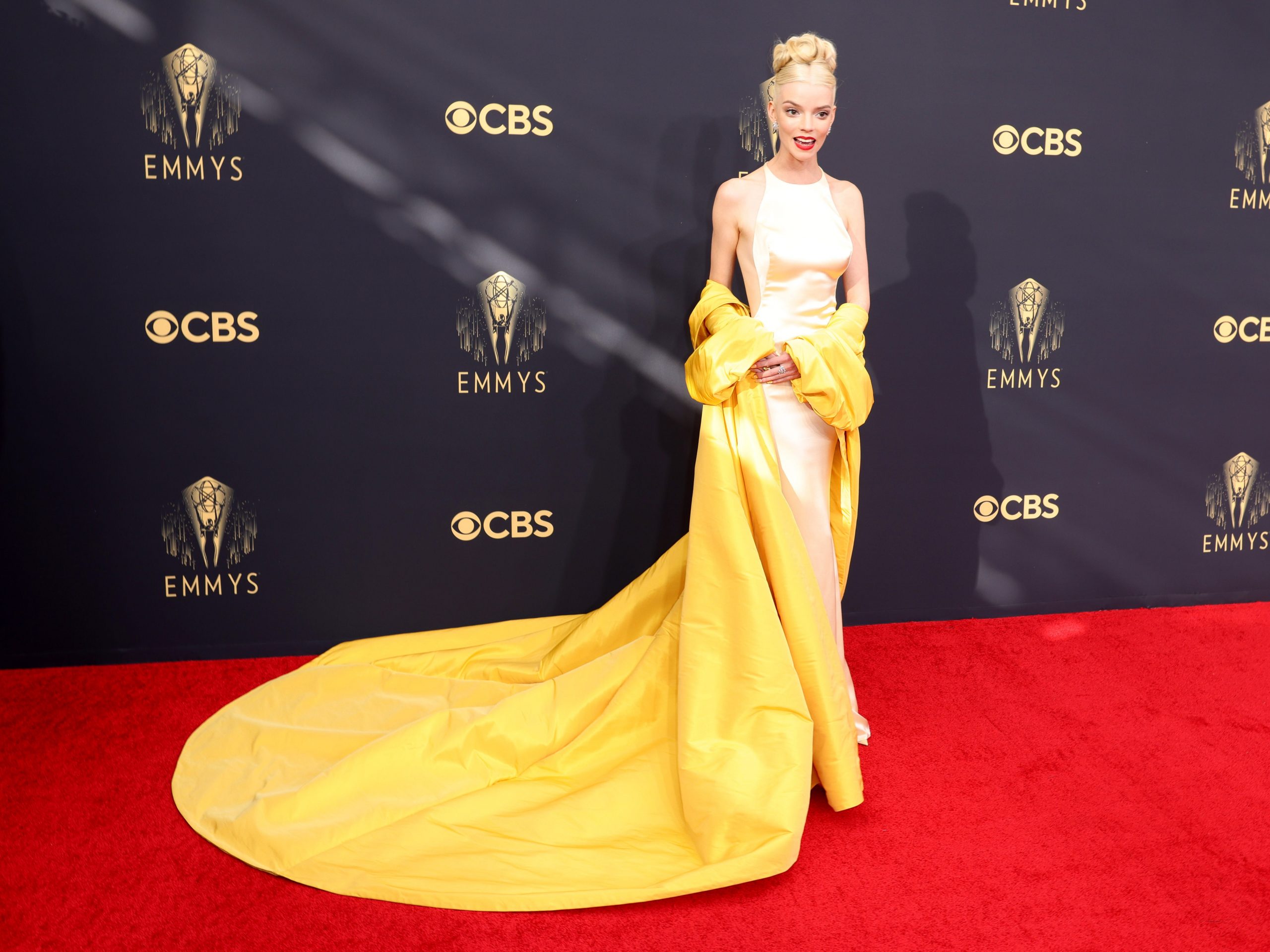 Anya Taylor-Joy wears a yellow dress on the Emmys red carpet.