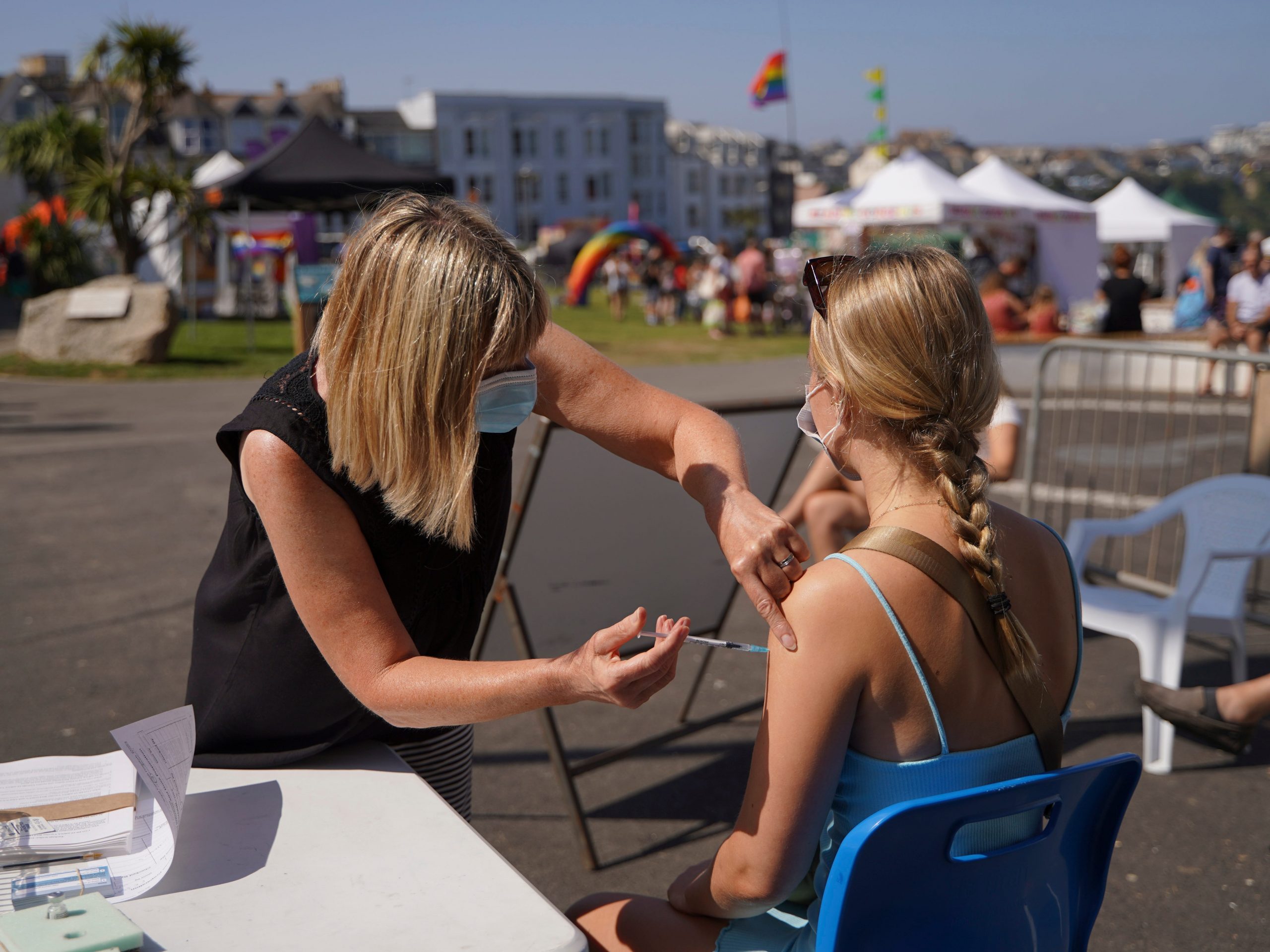 A member of the public is given a Covid vaccination by NHS staff during the first day of the Cornwall Pride LGBTQ+ festival on August 27, 2021 in Newquay, England.