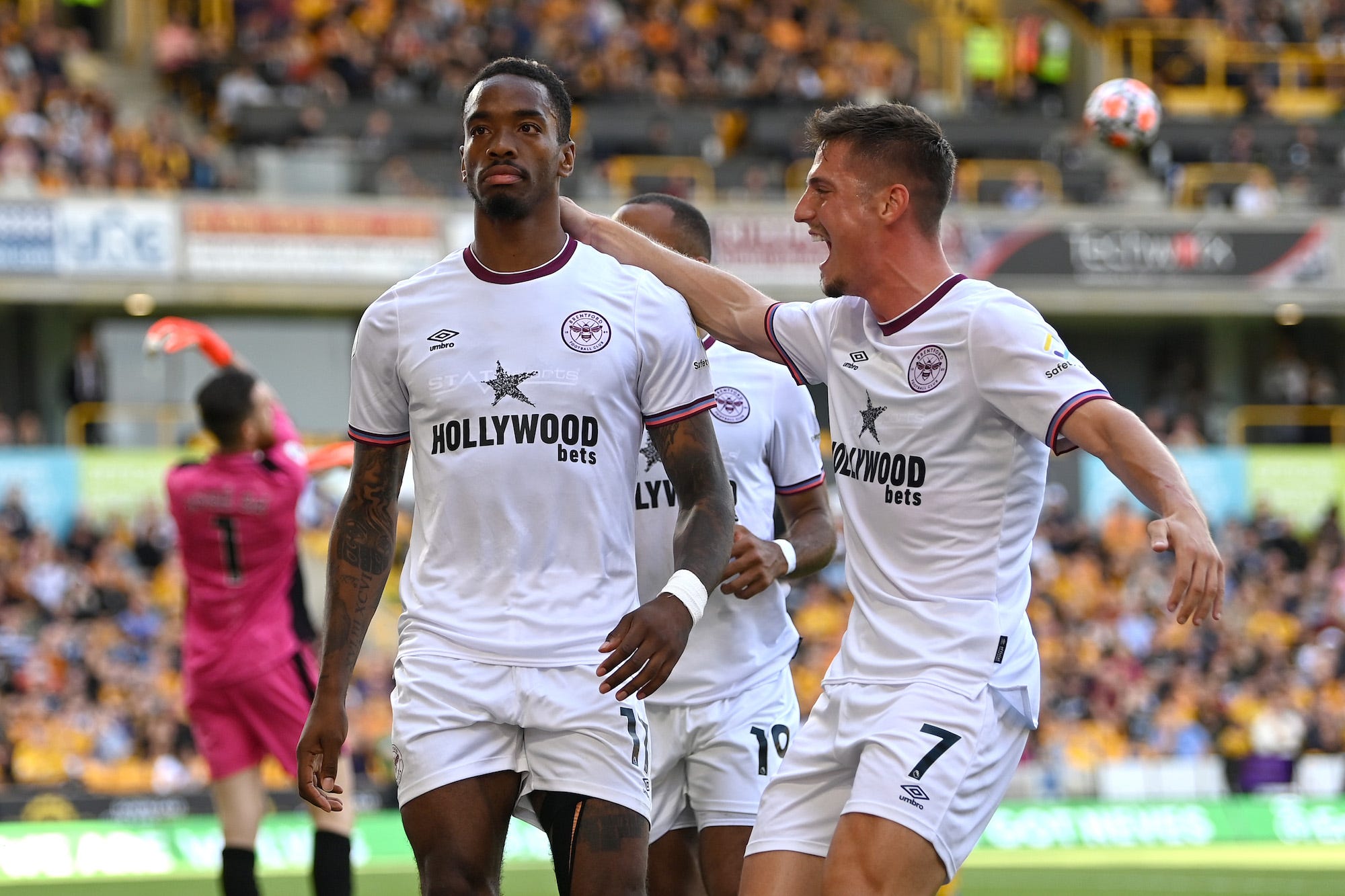 Ivan Toney of Brentford celebrates with teammate Sergi Canos after scoring their side's first goal during the Premier League match between Wolverhampton Wanderers and Brentford at Molineux on September 18, 2021 in Wolverhampton, England