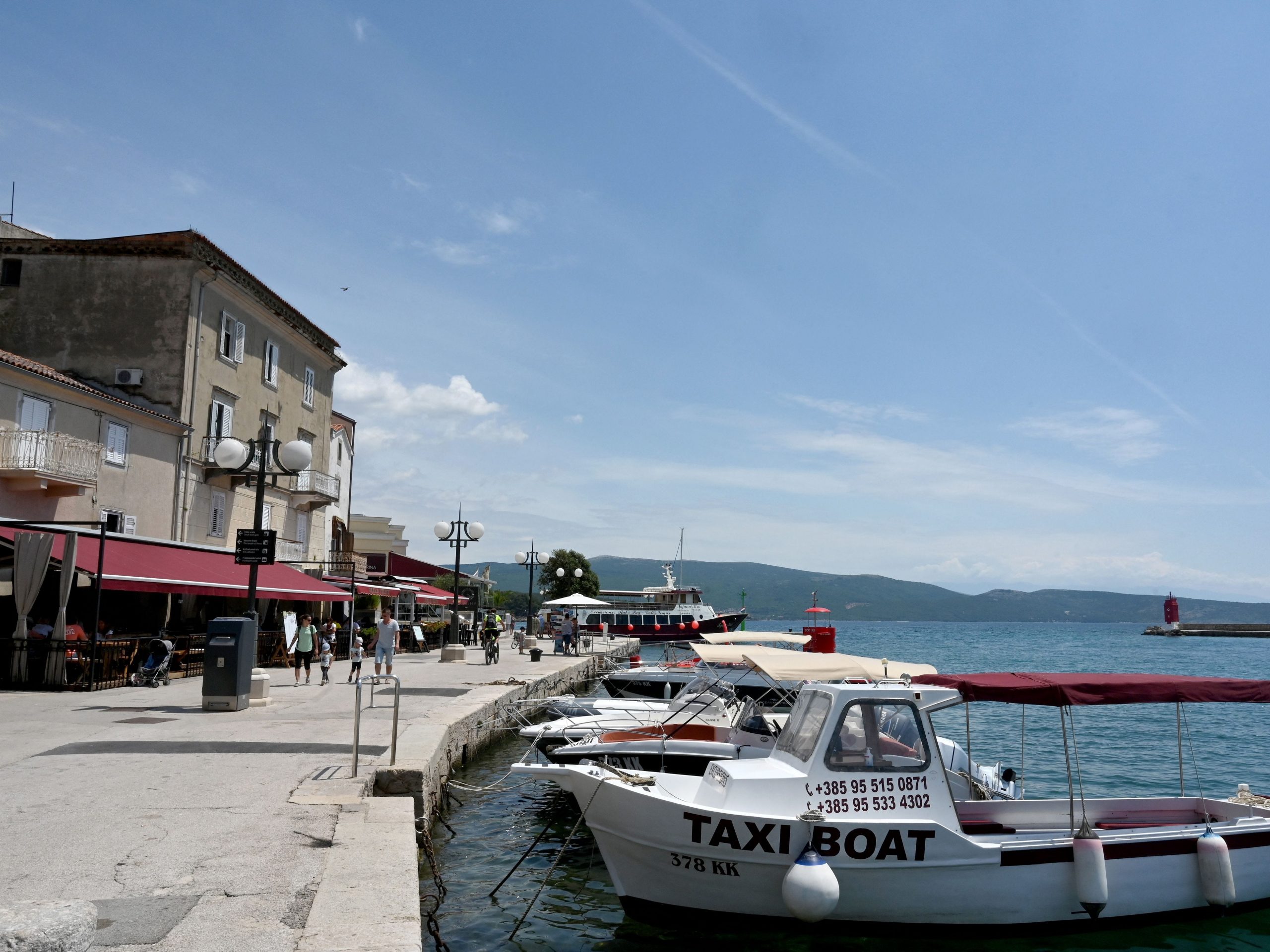 boats in a bay with blue skies in krk croatia