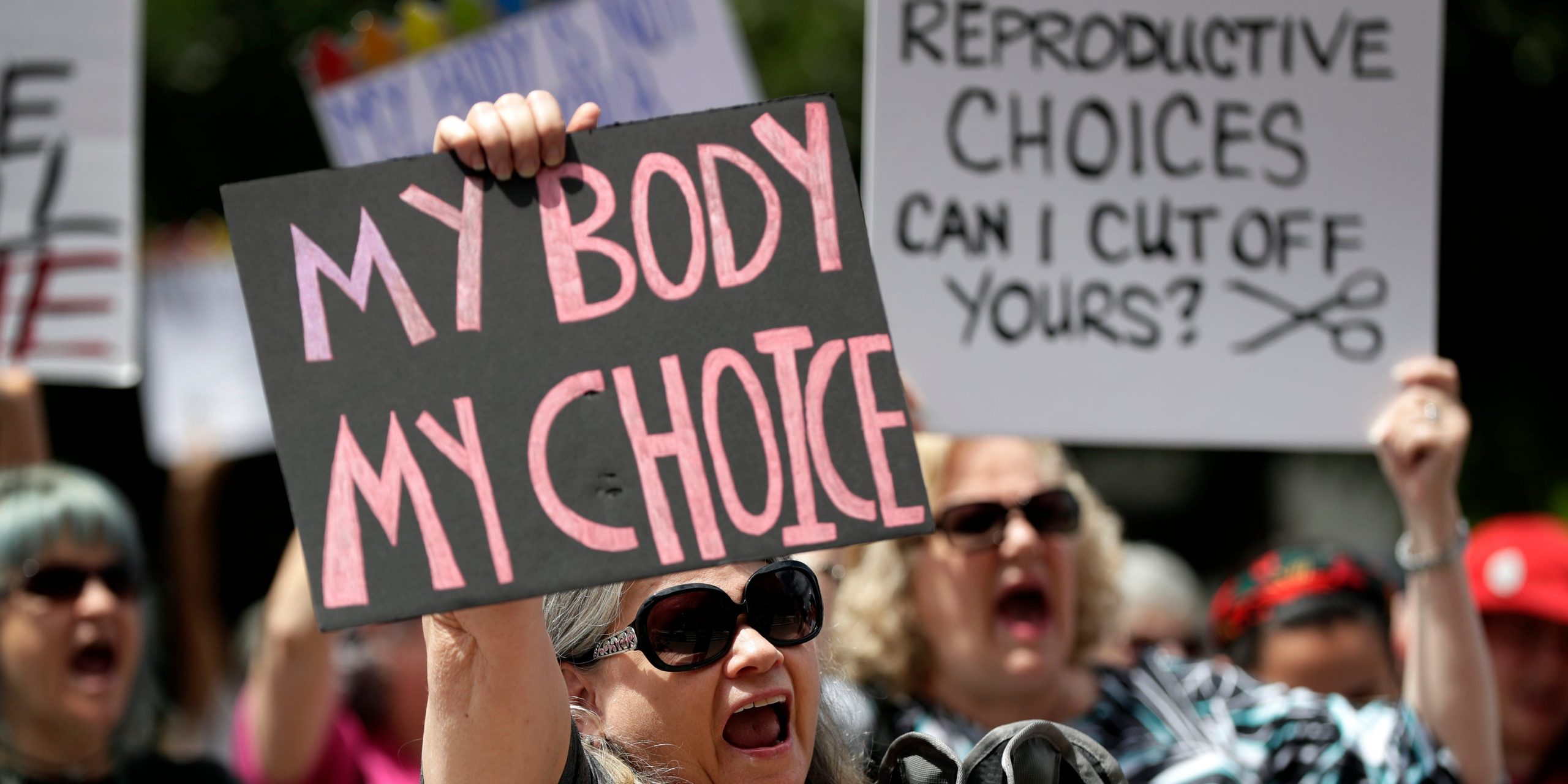 Protesters hold signs at an abortion rally at the Texas State Capitol in 2019.