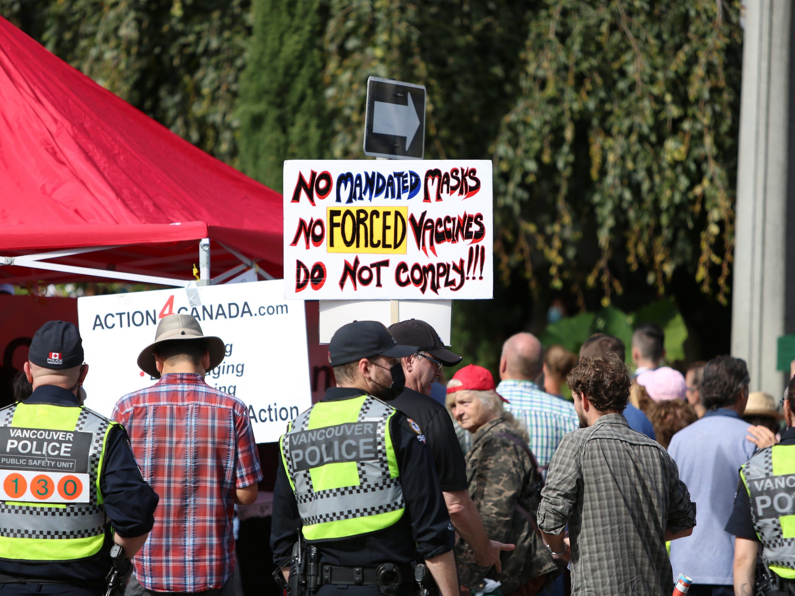 Protestors hold banners during a protest against BC Vaccine Card outside Vancouver City Hall on September 13, 2021 in Vancouver, British Columbia, Canada.