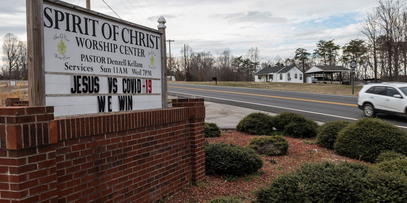 A church sign by the side of the road reads "Spirit of Christ Worship Center" then further down "Jesus vs COVID-19. We Won."