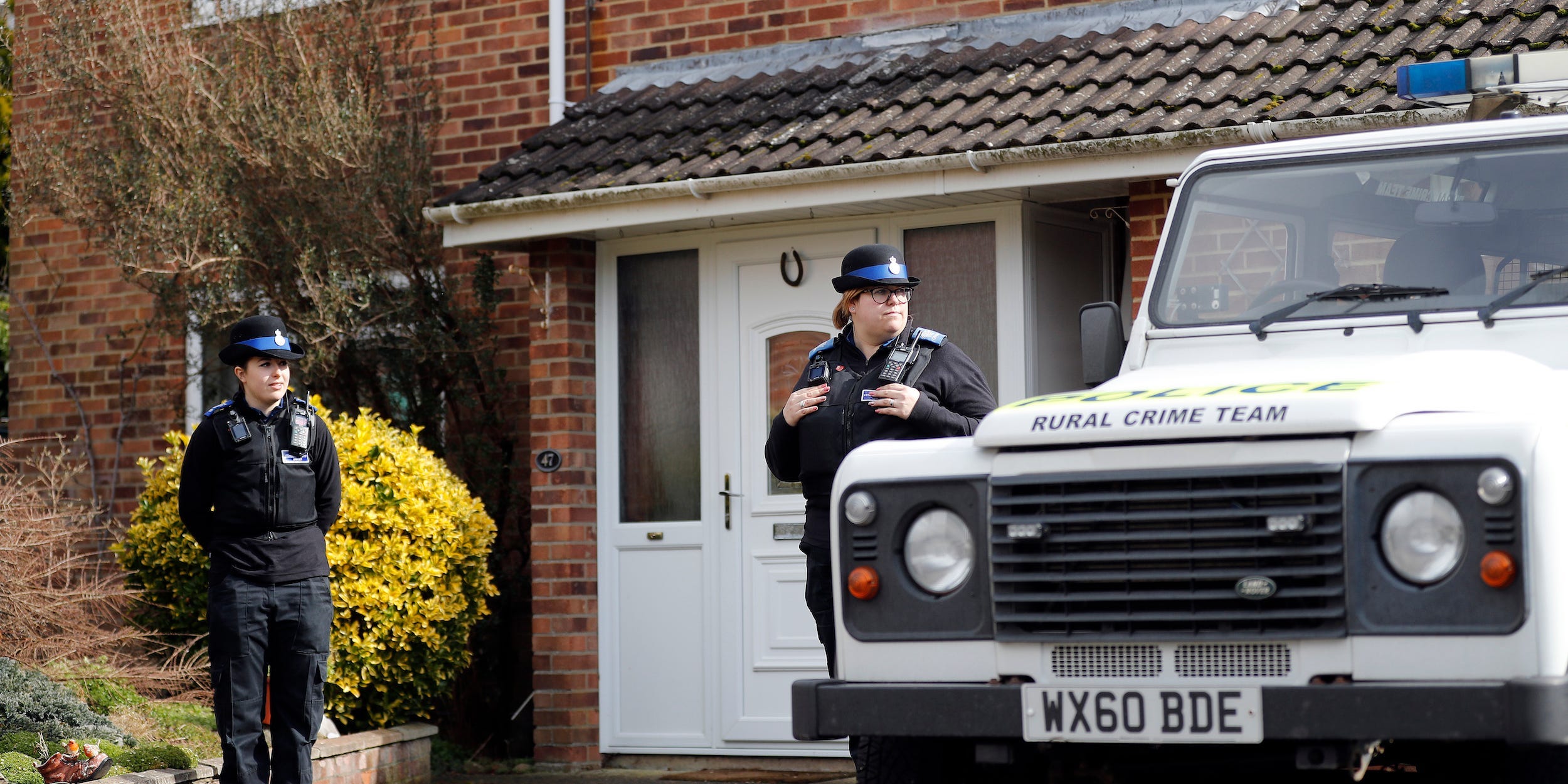 In this Tuesday, March 6, 2018 file photo, police officers stand outside the house of former Russian double agent Sergei Skripal who was found critically ill Sunday following exposure to an "unknown substance" in Salisbury, England.