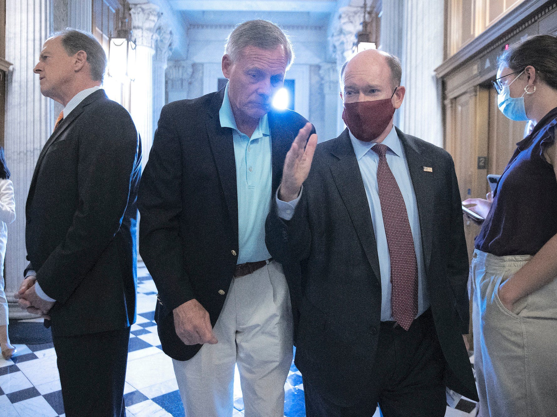 Sen. Richard Burr, a Republican of North Carolina, and Sen. Chris Coons, a Democrat of Delaware, talk as they head to the Senate Chamber for votes at the US Capitol on September 20, 2021.