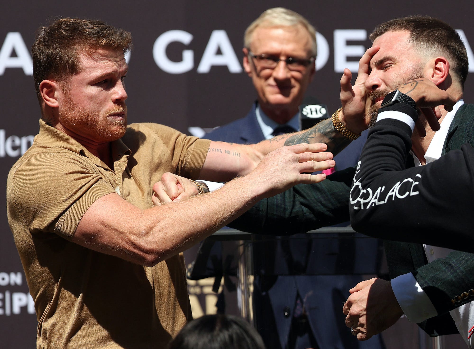 Canelo Alvarez slaps Caleb Plant at fiery press conference.
