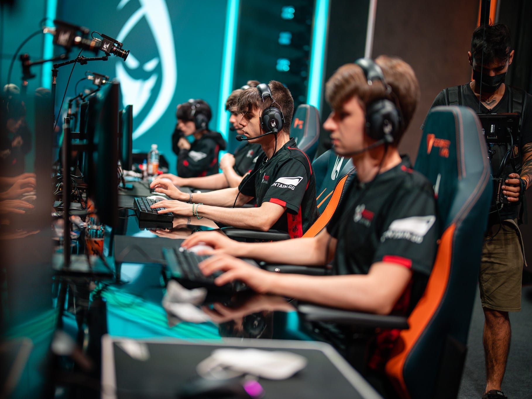 Four Misfits players sitting next two each other at their desks for a League of Legends match