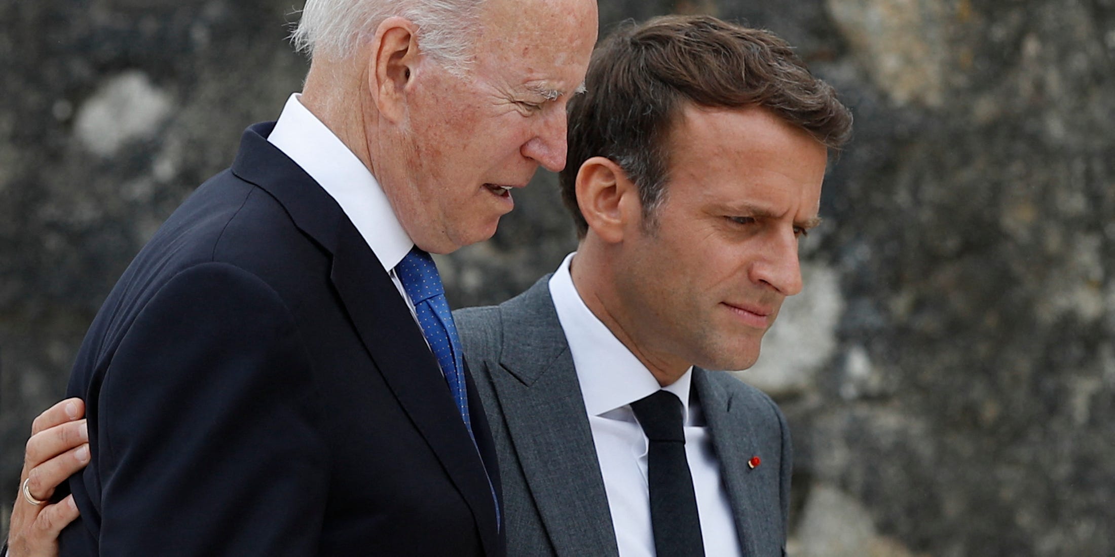 U.S. President Joe Biden (L) and France's President Emmanuel Macron walk along the boardwalk as they arrive at the G7 summit in Carbis Bay, Cornwall, on June 11, 2021.