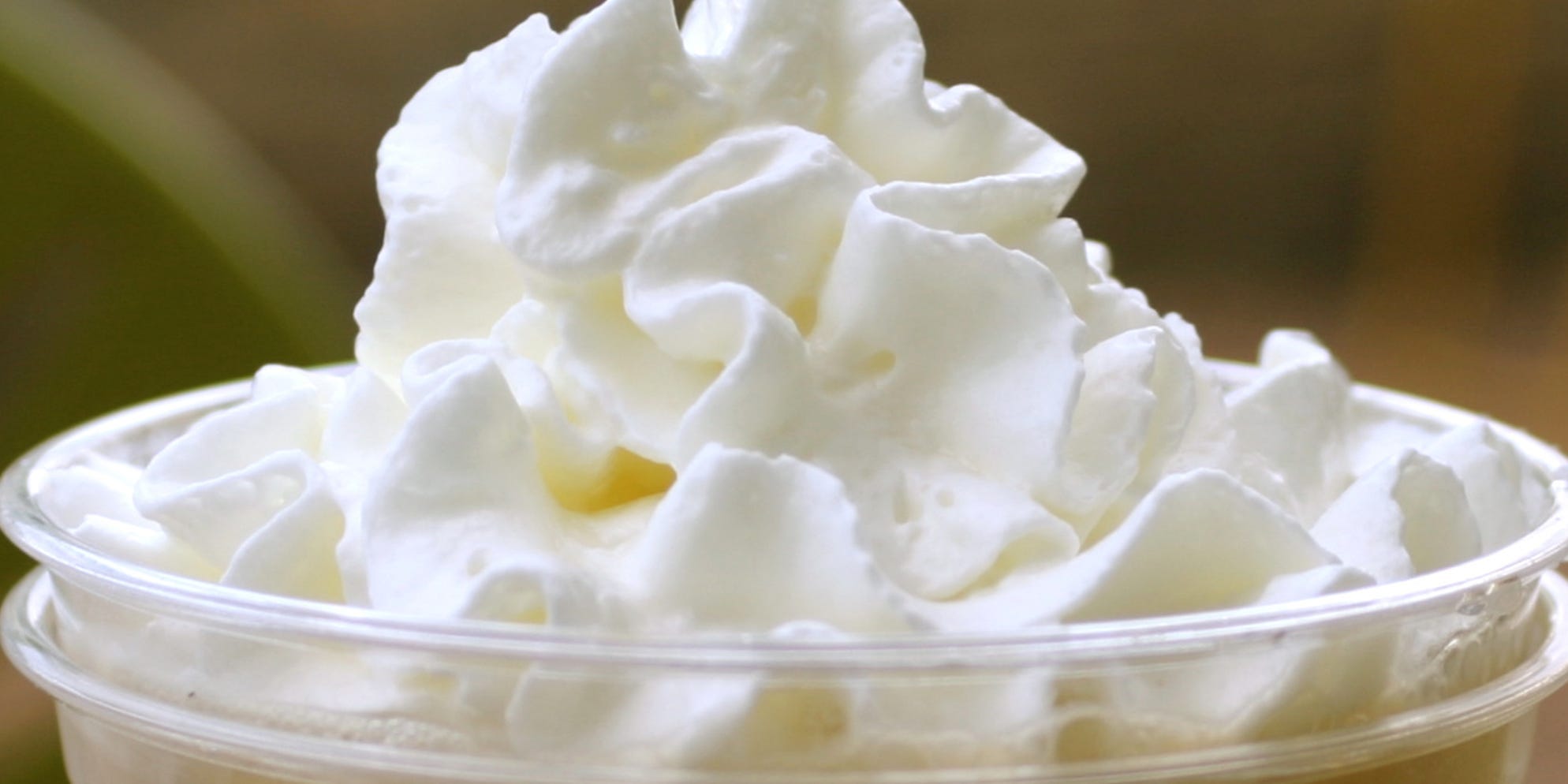 Some whipped cream on top of a drink.