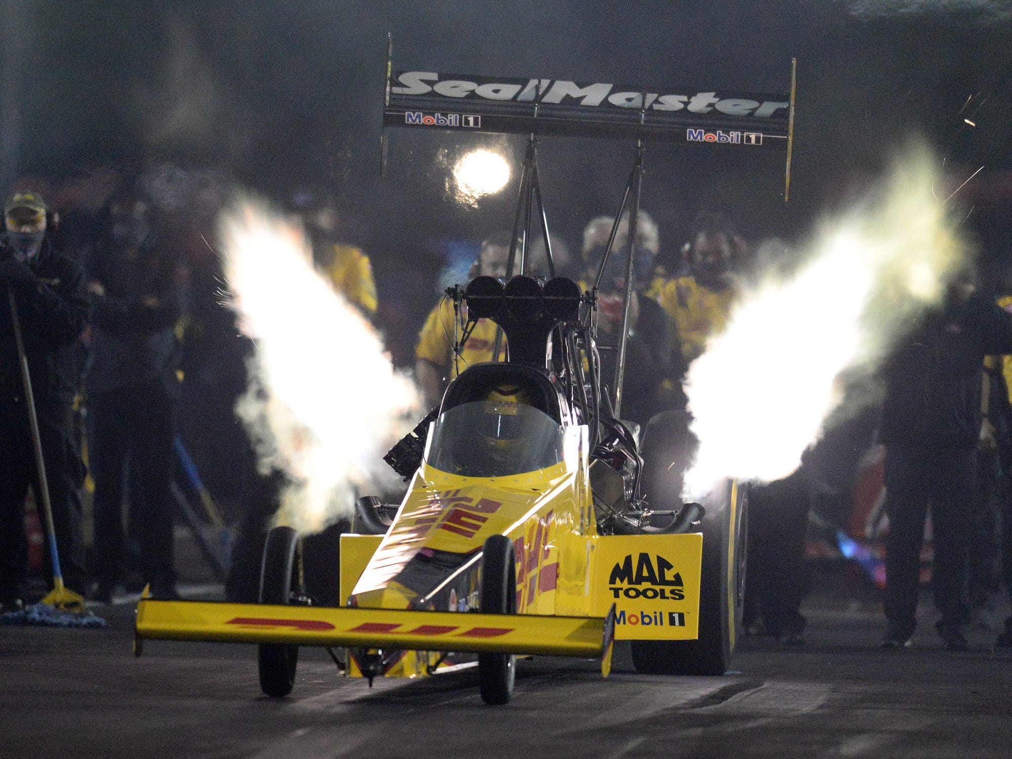 A race car with sparks flying off of it.