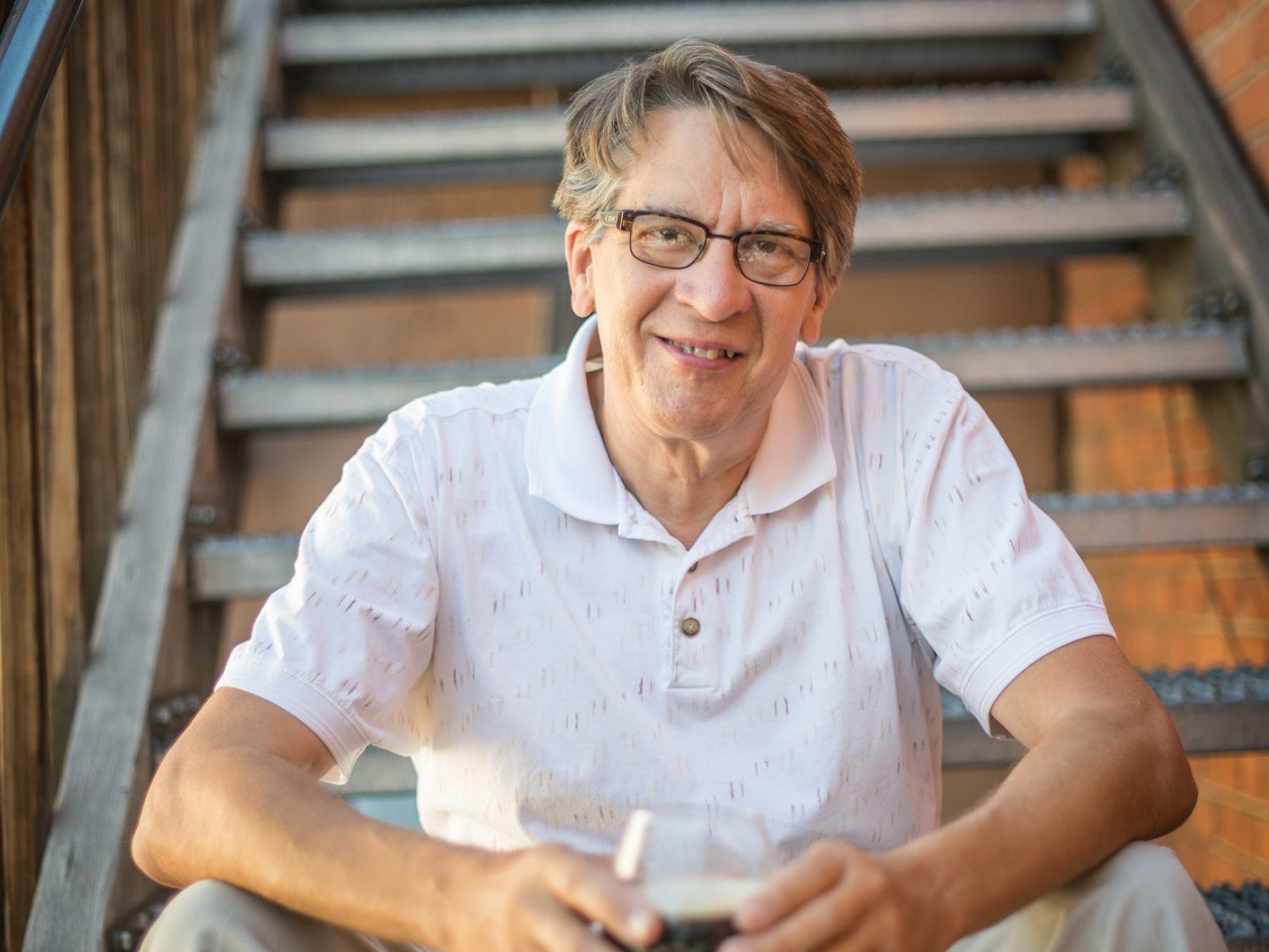 headshot of Chuck Skypeck holding beer on the steps
