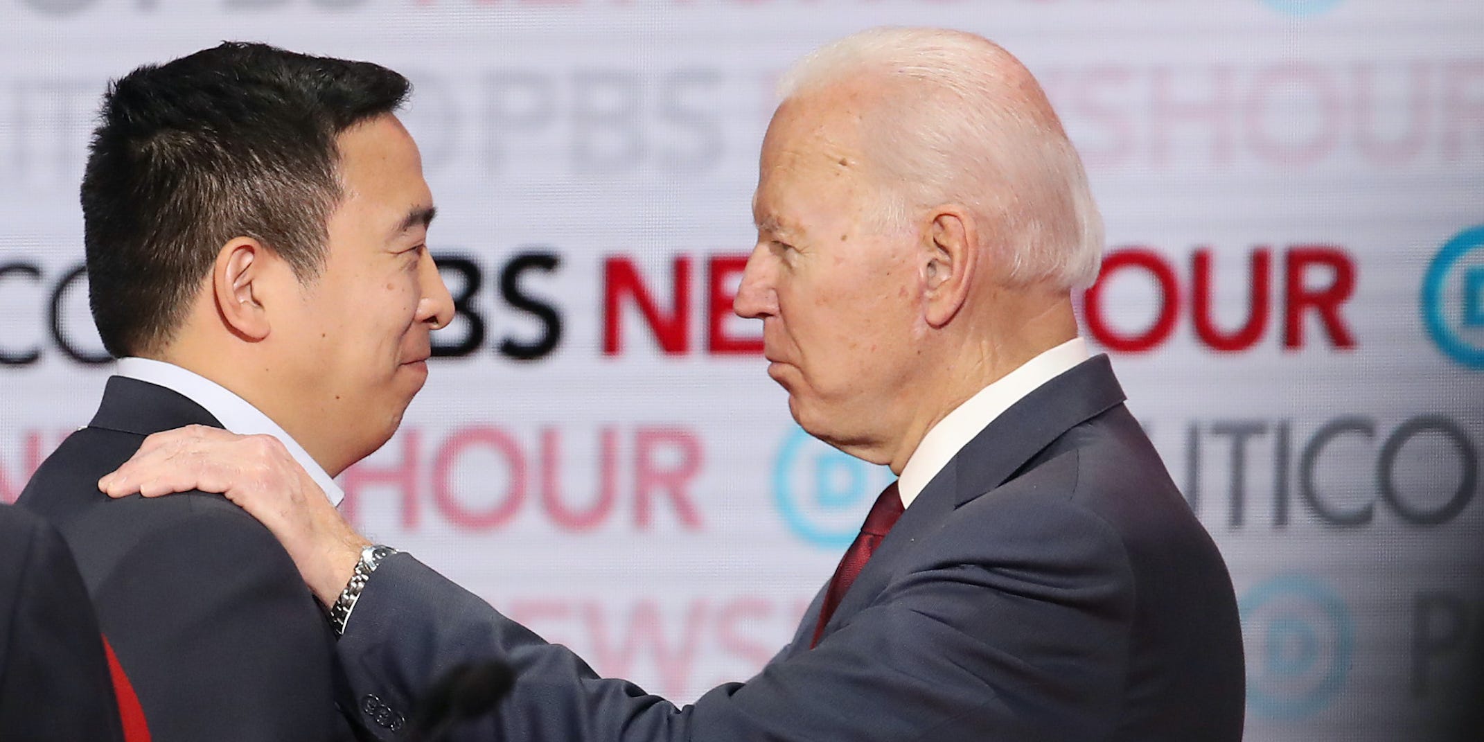 Democratic presidential candidate Andrew Yang (L) speaks with former Vice President Joe Biden during the Democratic presidential primary debate at Loyola Marymount University on December 19, 2019 in Los Angeles, California.