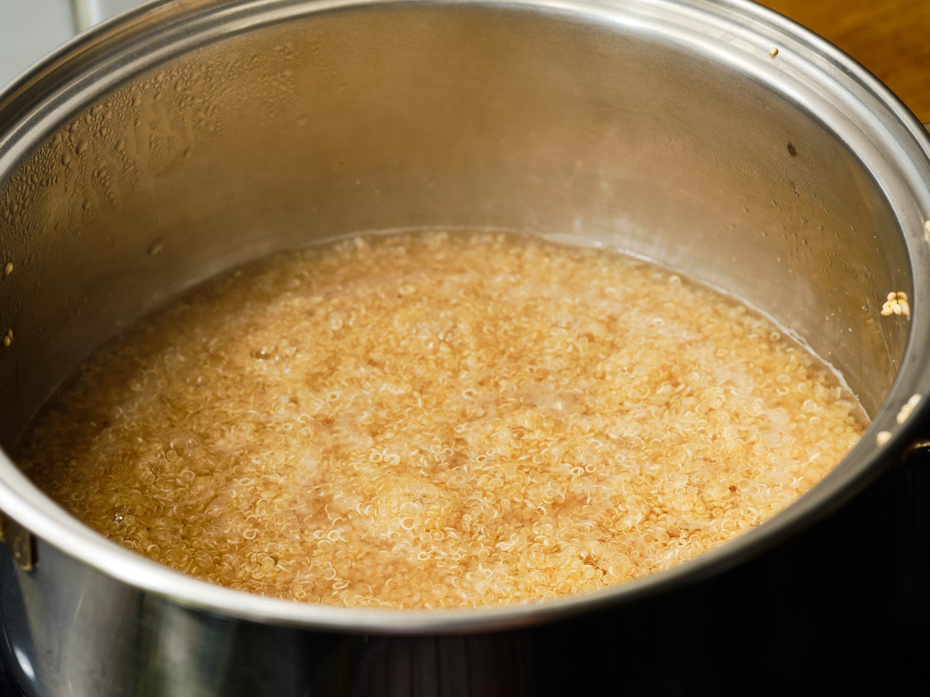 Quinoa getting cooked in a pot.