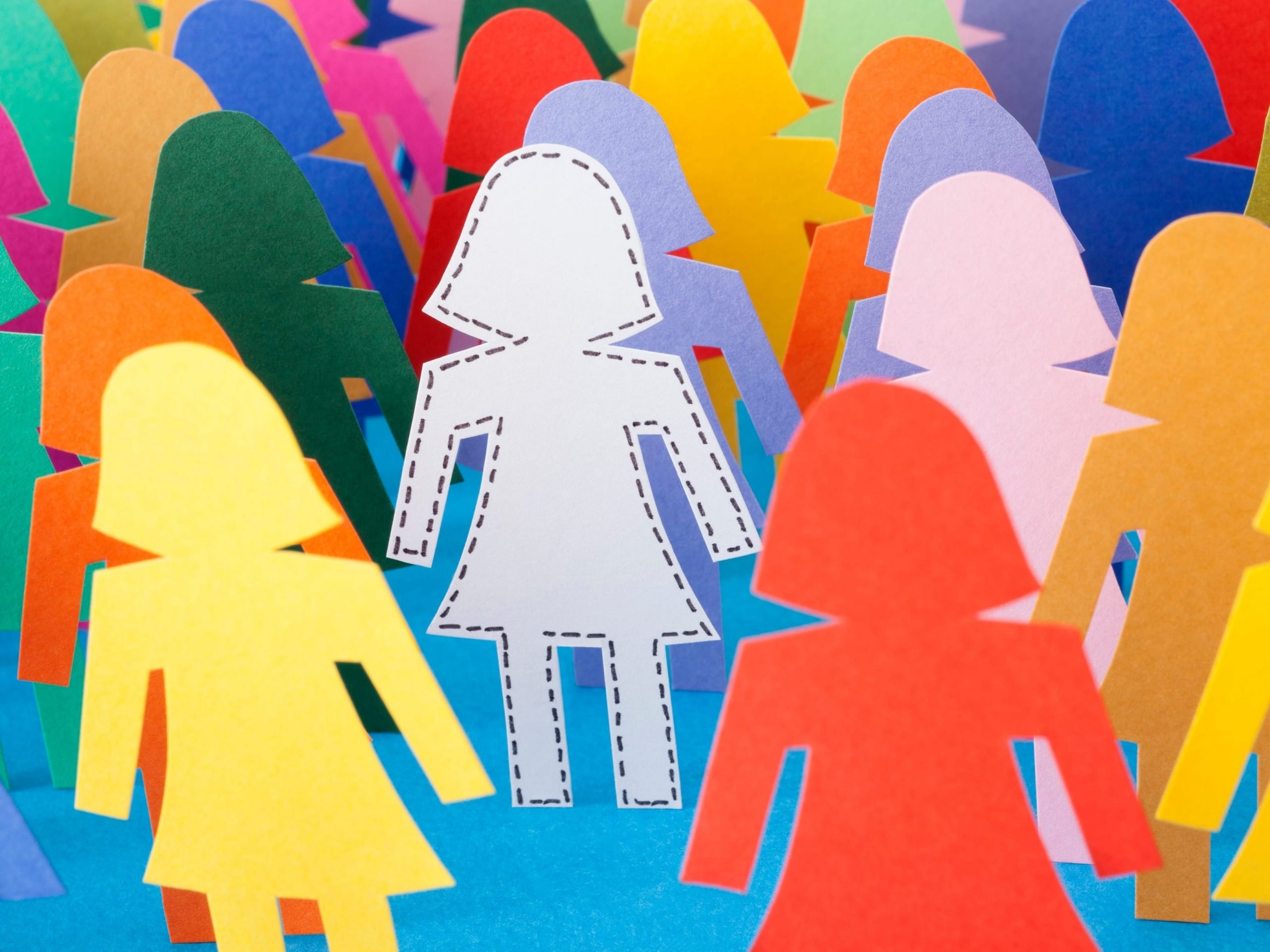 Female sticker figures in multiple colors standing while white stick figure is centered.