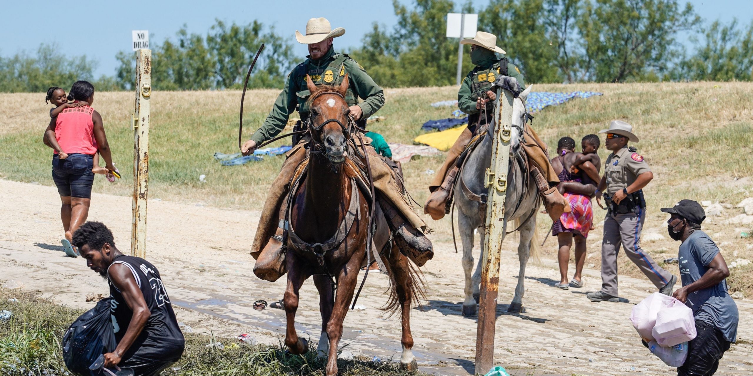 United States Border Patrol agents on horseback try to stop Haitian migrants from entering an encampment on the banks of the Rio Grande near the Acuna Del Rio International Bridge in Del Rio, Texas on September 19, 2021. - US law enforcement are attempting to close off crossing points along the Rio Grande river where migrants cross to get food and water, which is scarce in the encampment. The United States said Saturday it would ramp up deportation flights for thousands of migrants who flooded into the Texas border city of Del Rio, as authorities scramble to alleviate a burgeoning crisis for President Joe Biden's administration.