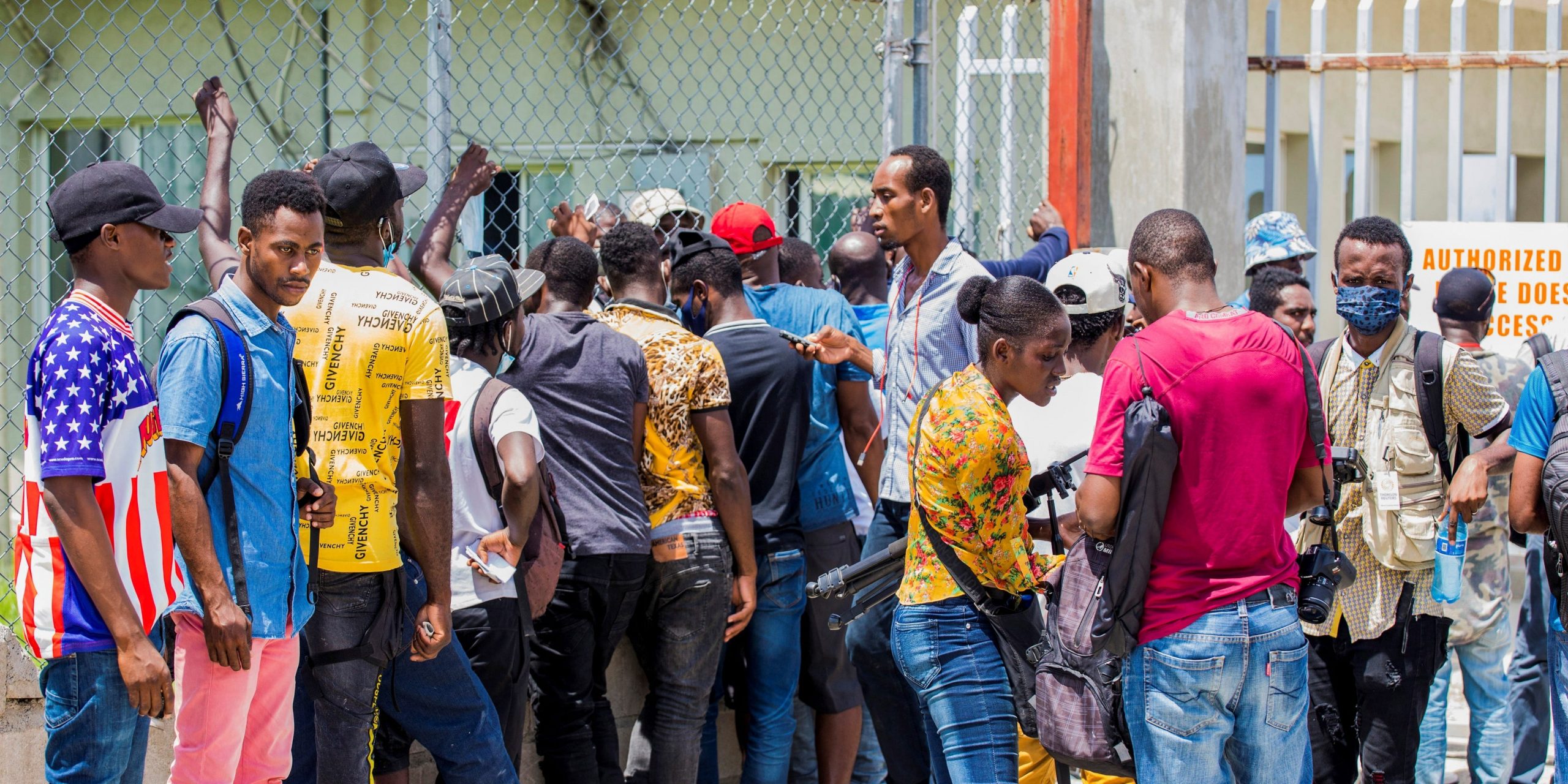 Haitian migrants line up outside of Toussaint Louverture International Airport in Port-au-Prince, Haiti September 22, 2021.