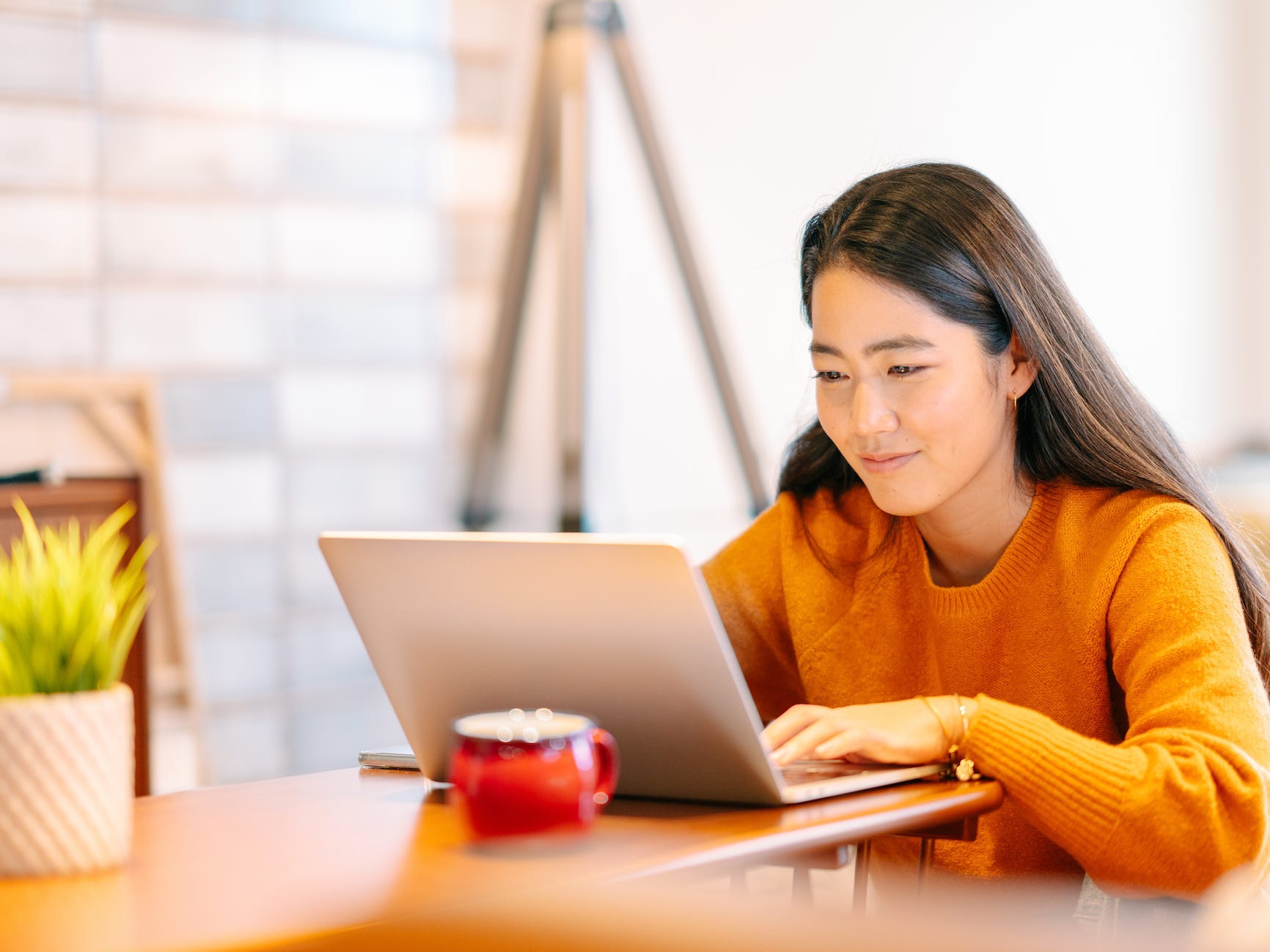 a woman working from home and using her laptop