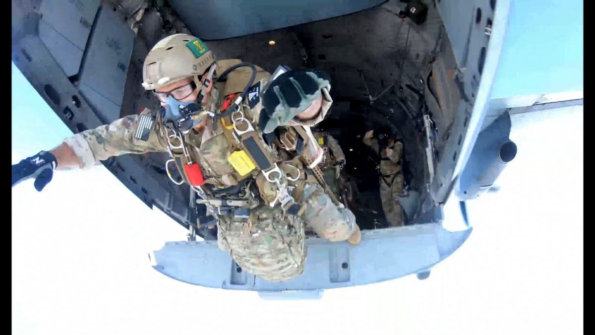 A Special Operations Sniper exits a C-27 aircraft with his MK-22 Precision Sniper Rifle (PSR) in the “side-mounted” configuration over Laurinburg drop zone, Laurinburg, North Carolina, during the PSR test