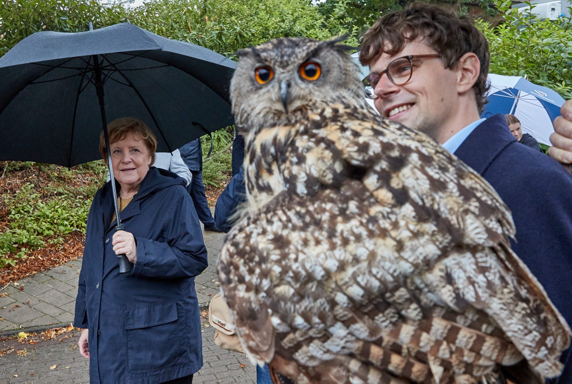 Angela Merkel looking at an owl.