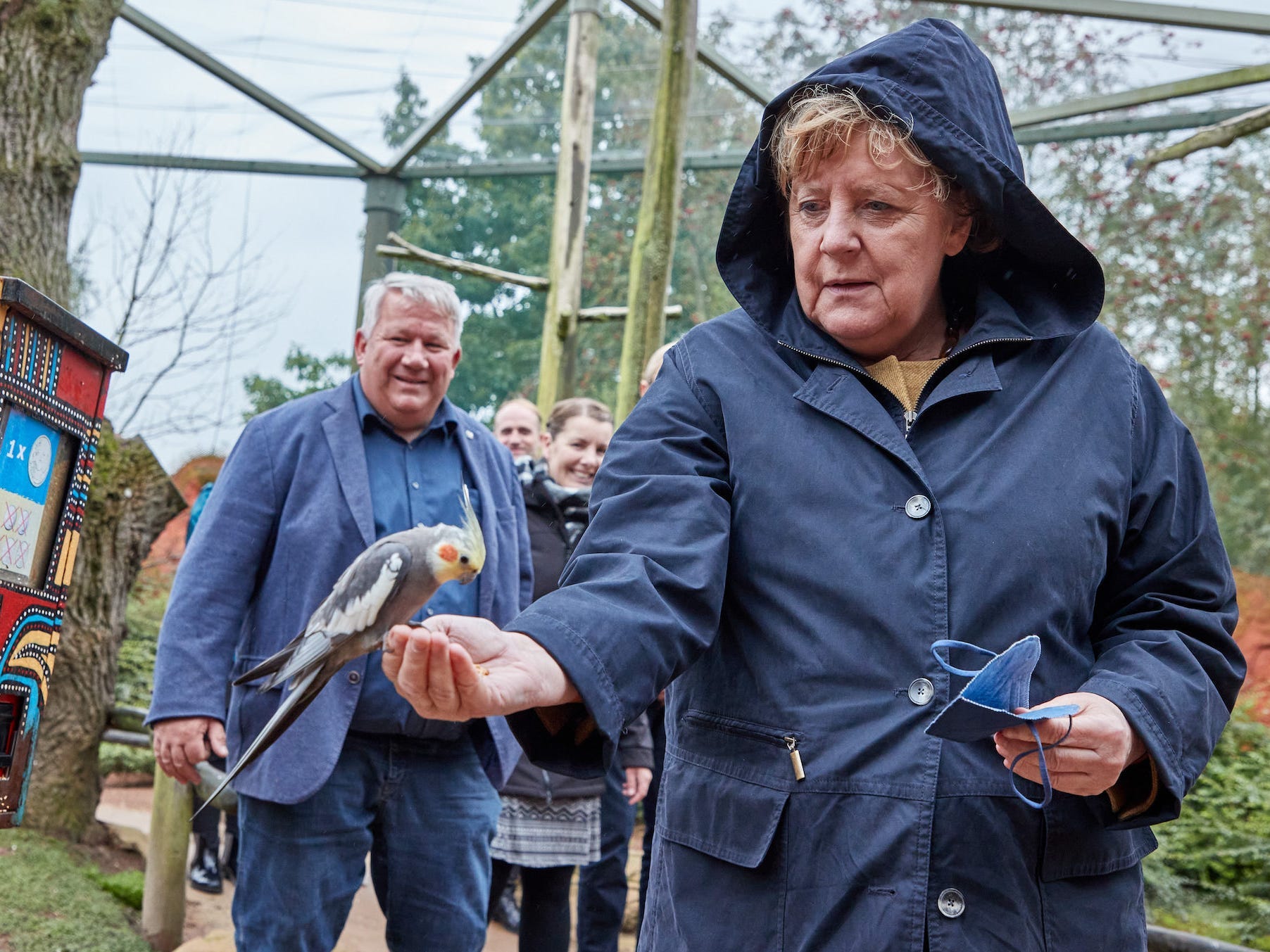 Merkel feeding a bird.