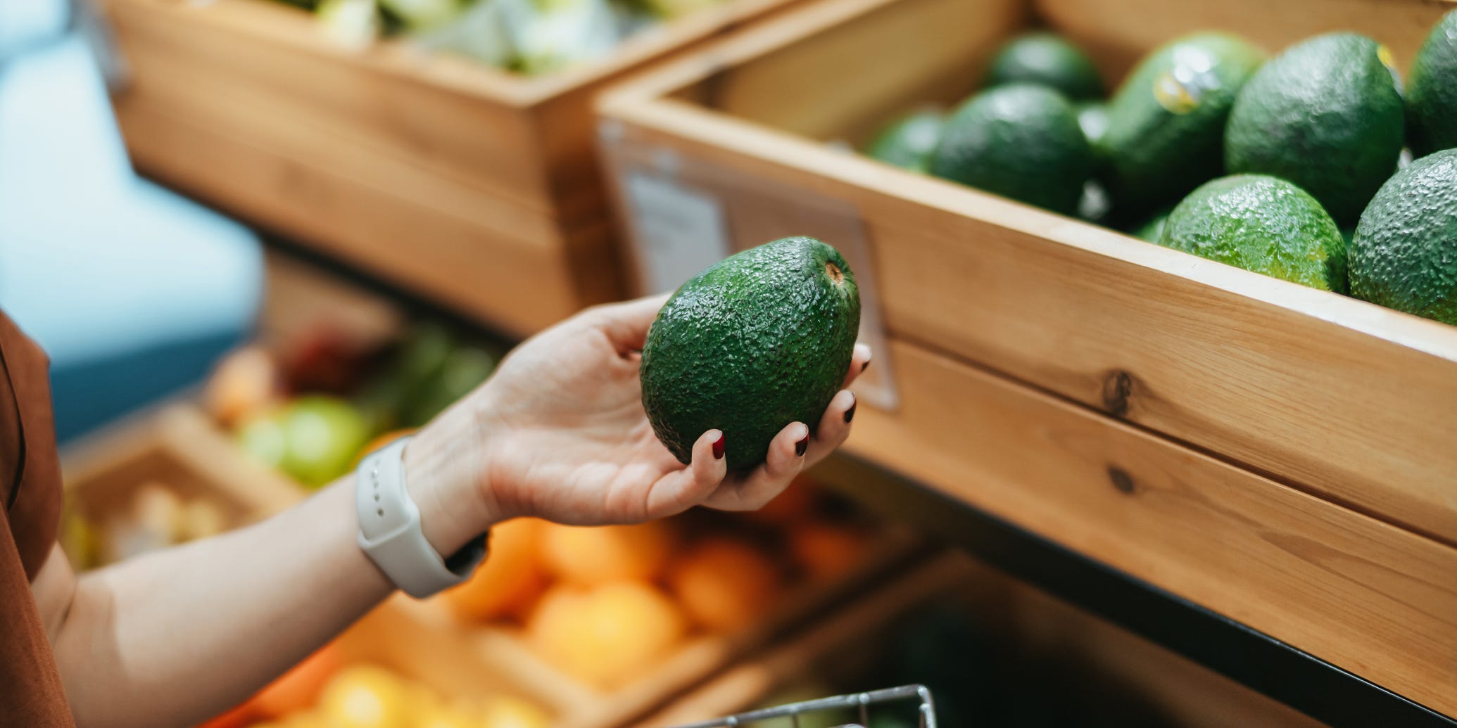 Someone holding an avocado.