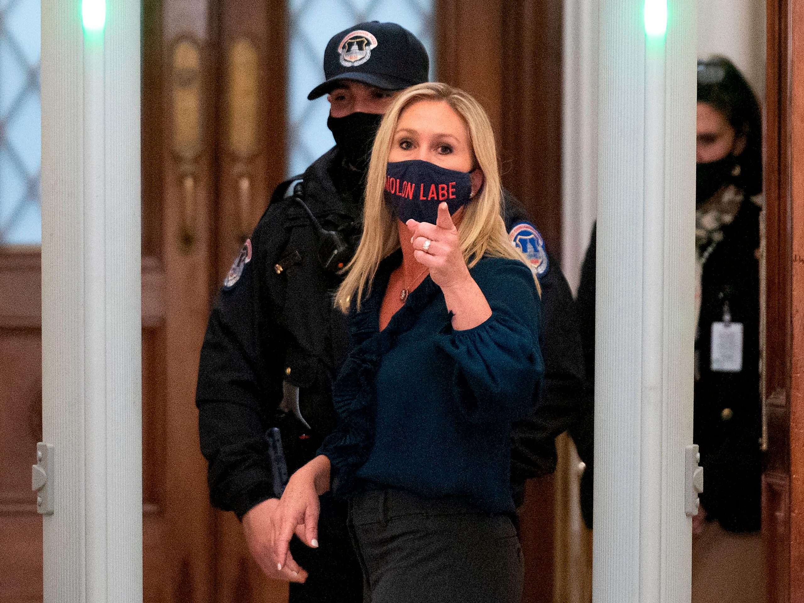 Republican Rep. Marjorie Taylor Greene of Georgia shouts at journalists as she goes through security outside the House Chamber at Capitol Hill on January 12, 2021.