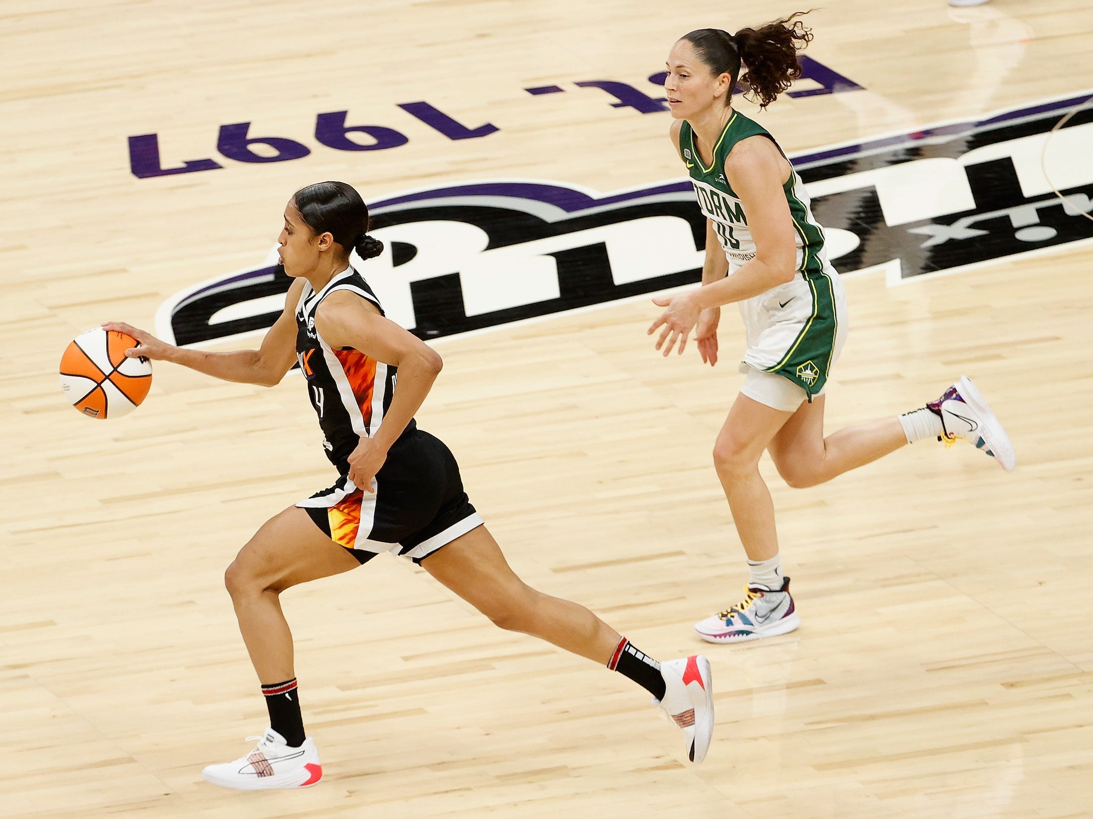 Mercury point guard Skylar Diggins-Smith dribbles past Sue Bird of the Seattle Storm.