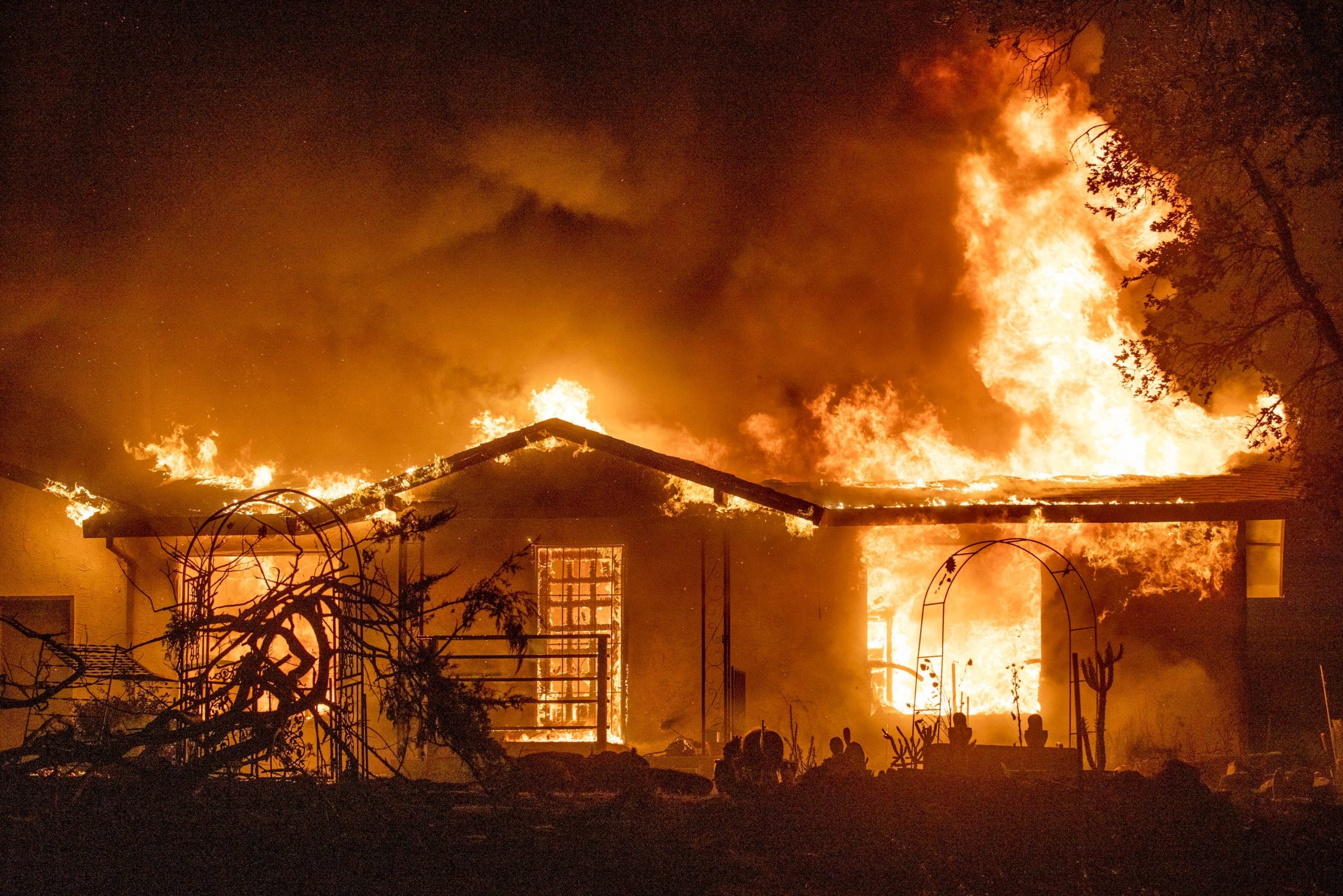 In this Sept. 27, 2020, file photo, a house burns on Platina Road at the Zogg Fire near Ono, Calif.