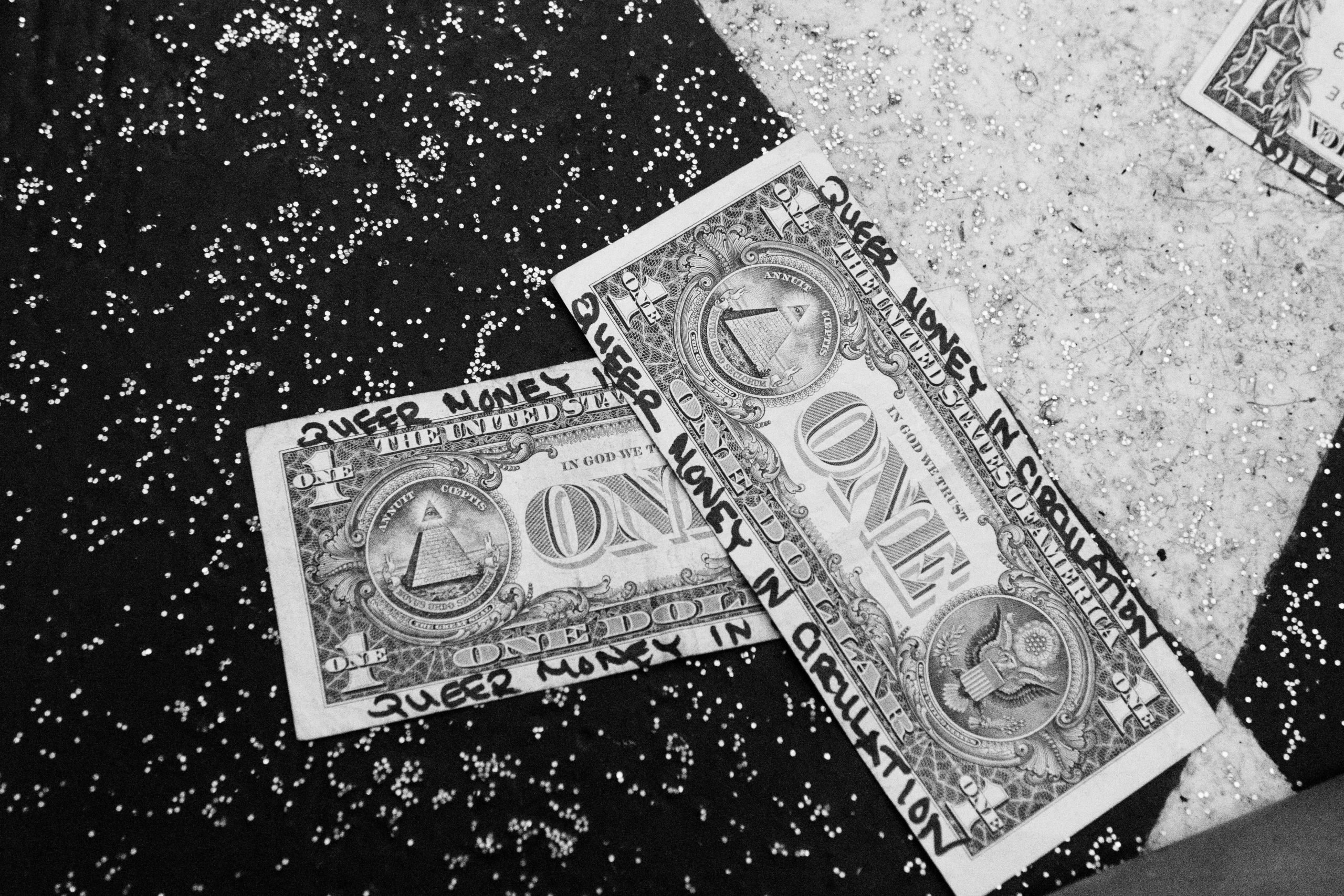 Dollar bills labeled "Queer Money in Circulation"