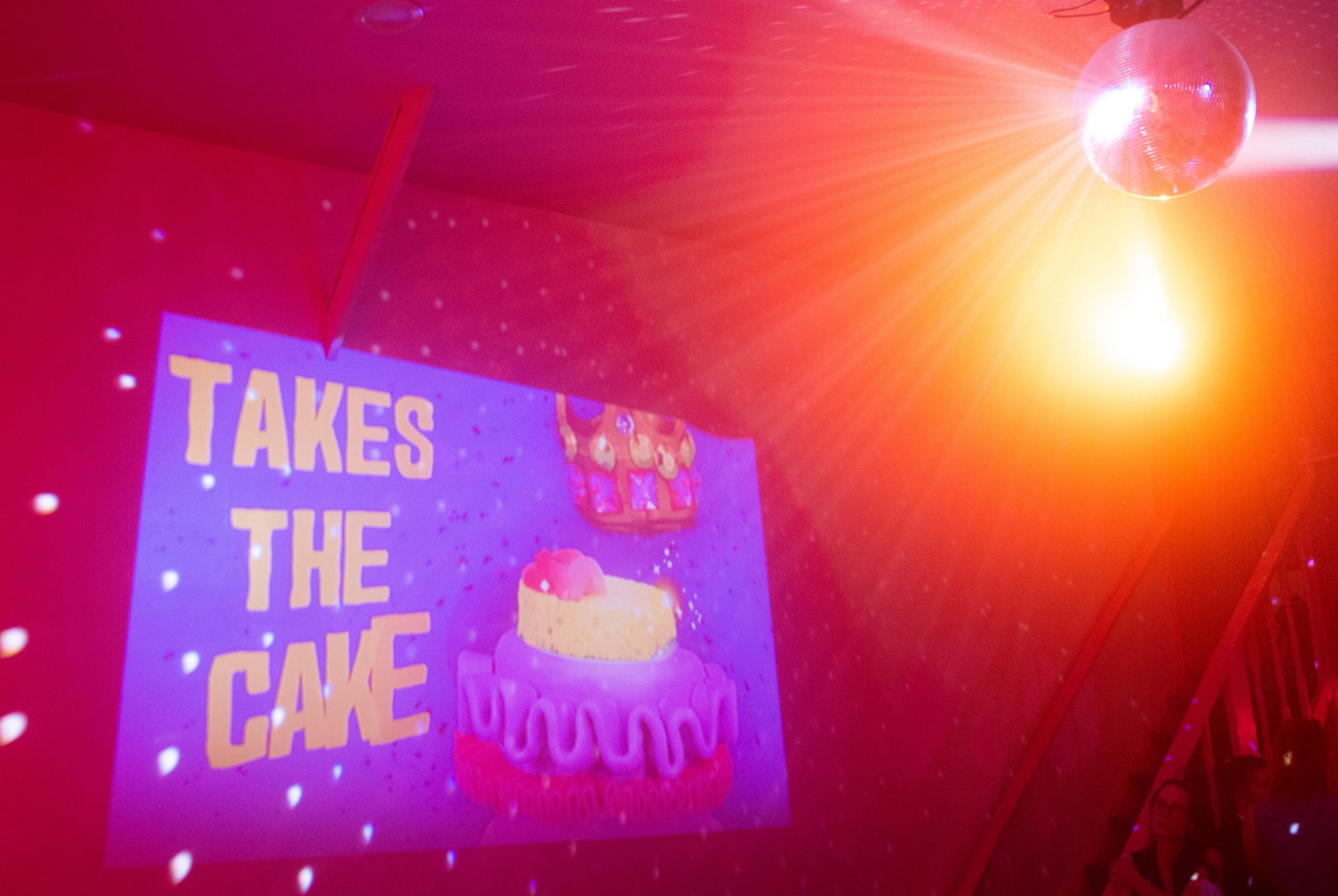 A sign advertises "Takes the Cake"